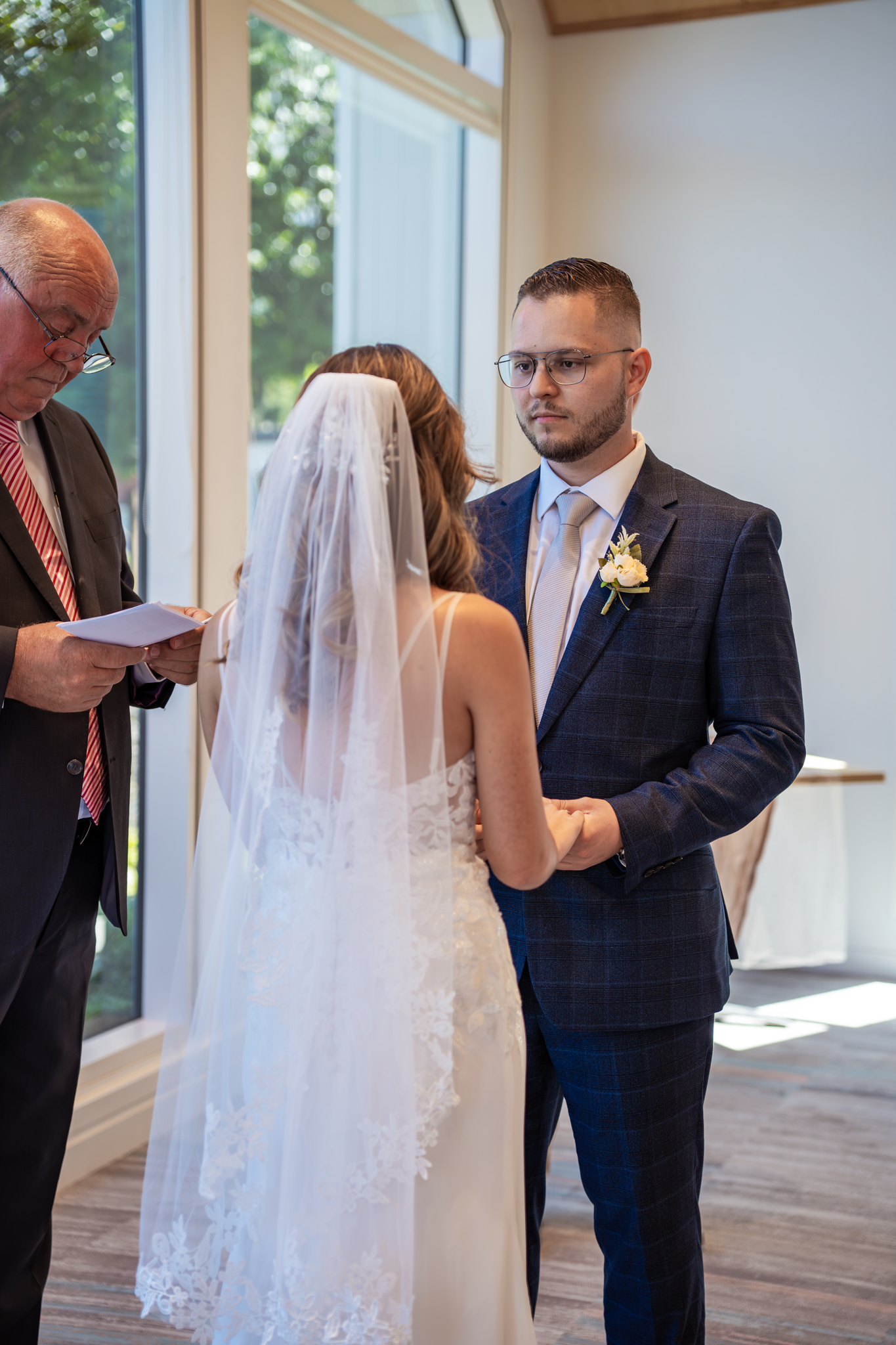 A wedding ceremony in progress with an officiant leading the service.