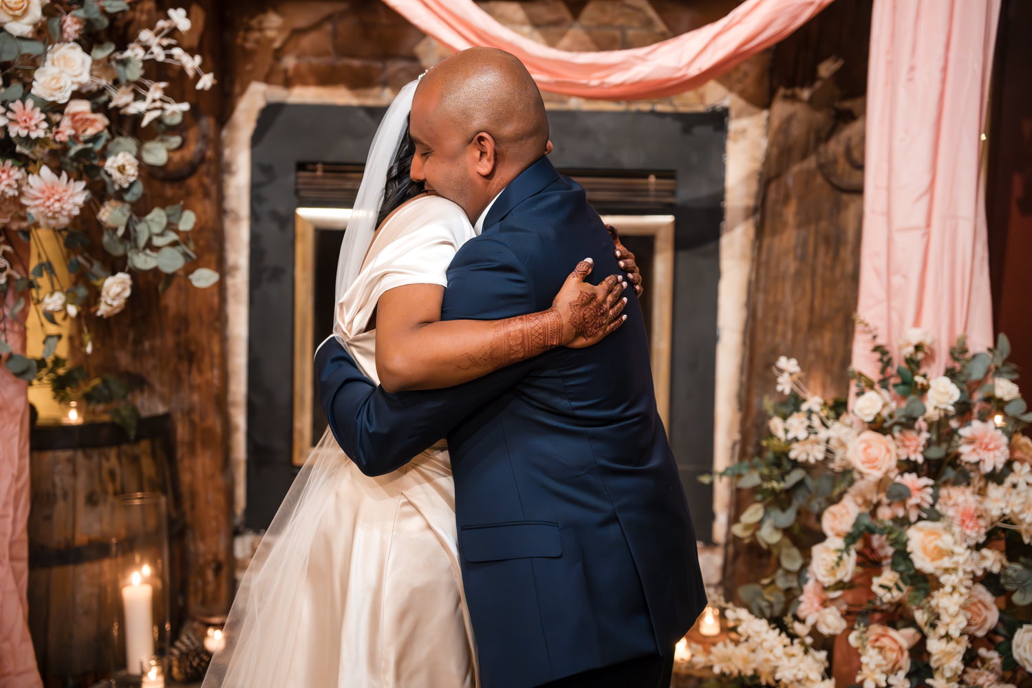 A couple shares their first dance in a beautifully decorated wedding venue with floral arrangements.