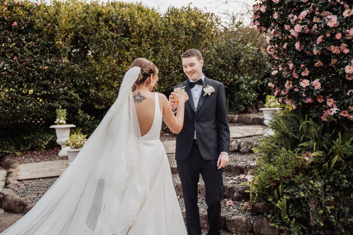 Wedding ceremony celebration with guests and floral decor in an outdoor garden setting.