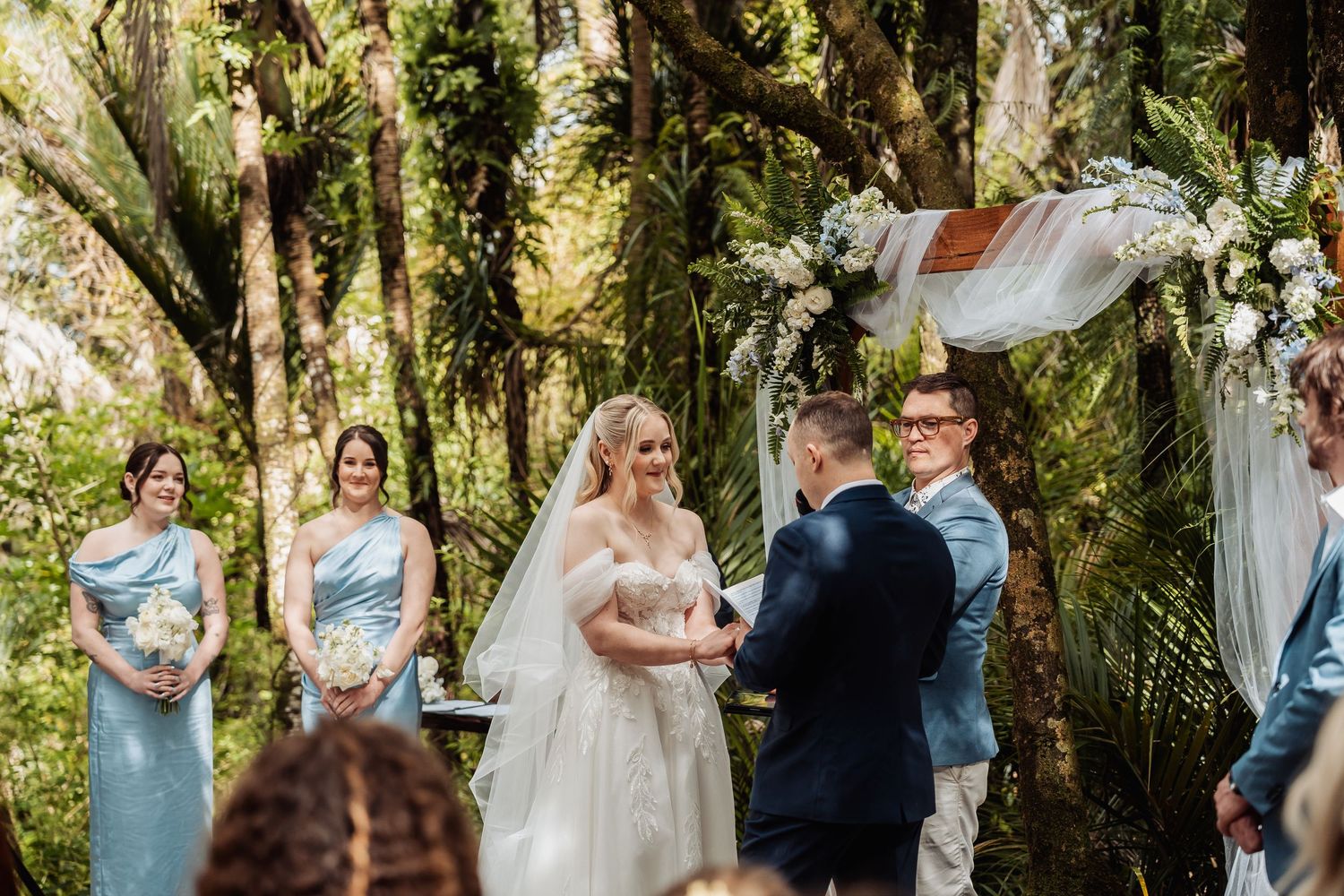 Wedding ceremony group photos taken in a scenic wooded outdoor setting.