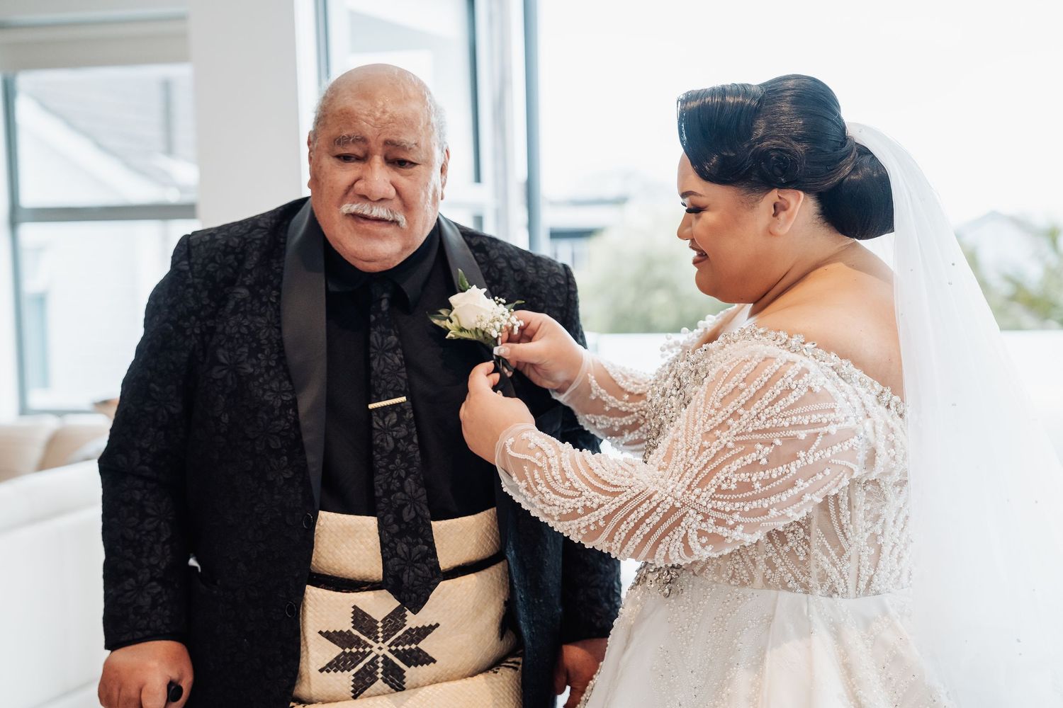 Wedding preparations showing attaching details and accessories before the ceremony.
