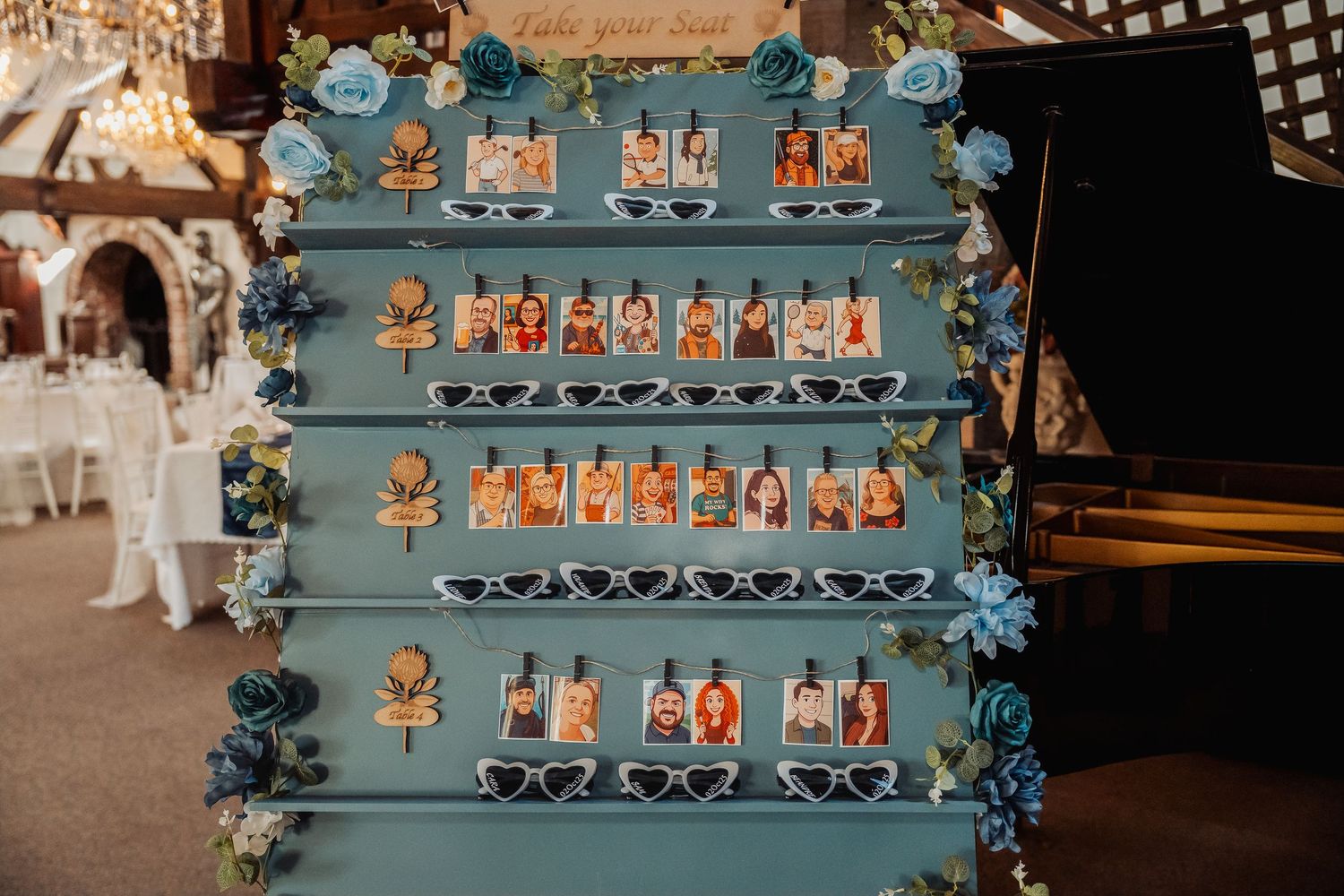A decorative blue display shelf adorned with small figurines and floral accents at a wedding event.