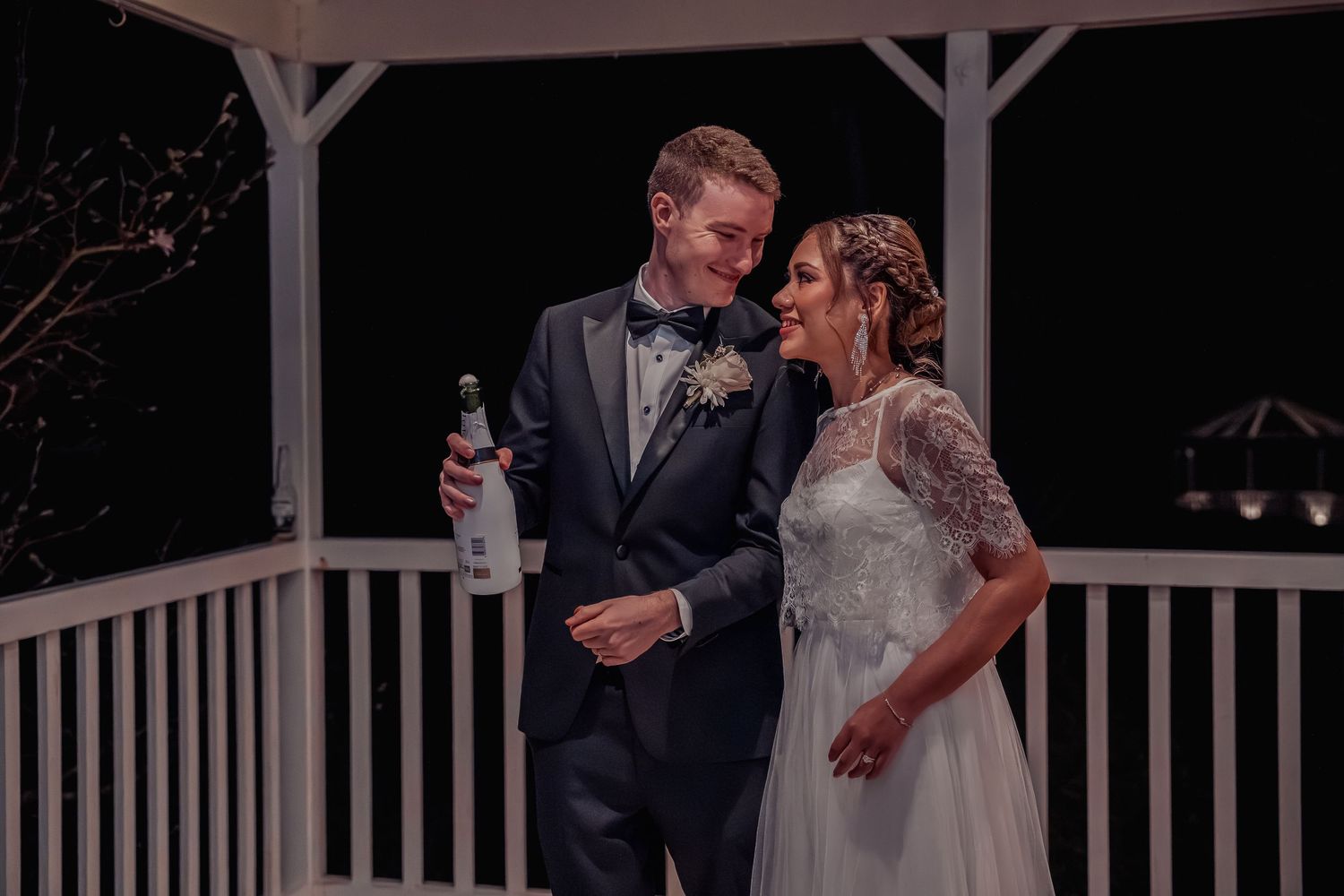 A romantic evening reception scene with soft lighting and elegant decor.
