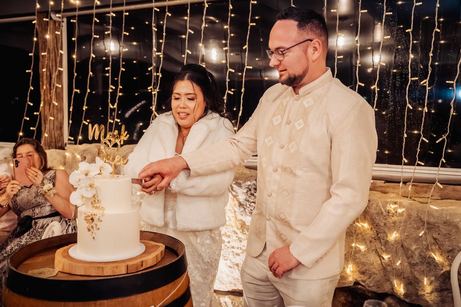 Wedding reception venue decorated with hanging string lights creating a romantic ambiance.