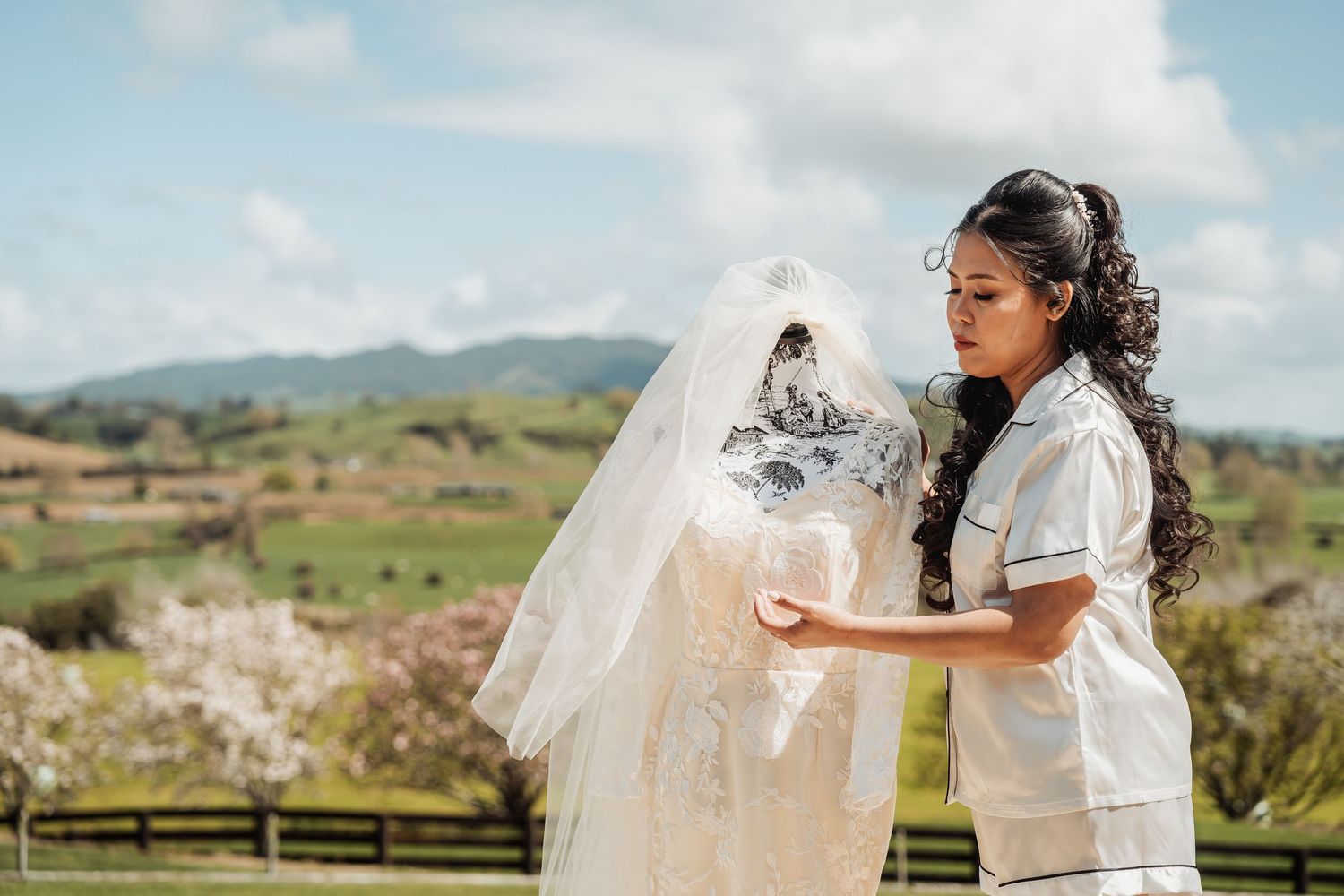 Wedding photographer captures intimate moments with couple against scenic mountain landscape backdrop.