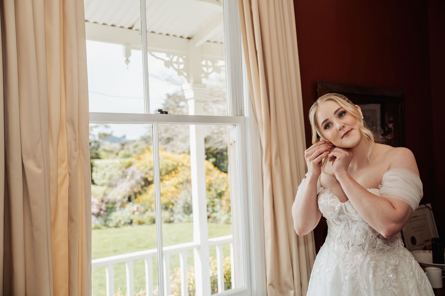 Getting ready shots in a sunlit room with elegant decor and flowing curtains.