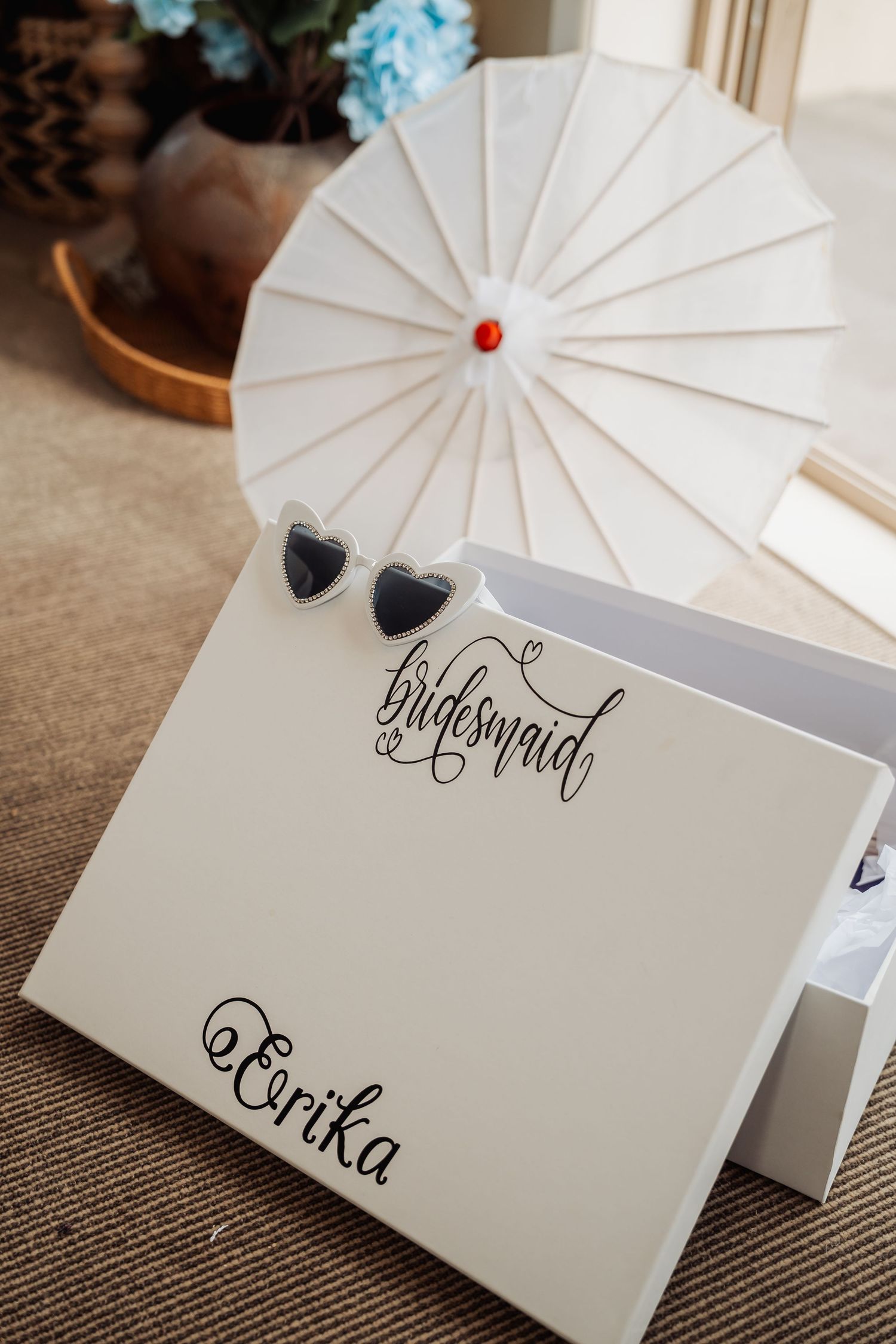 White bridesmaid gift box personalized with name Erika, featuring heart-shaped sunglasses and elegant calligraphy script.