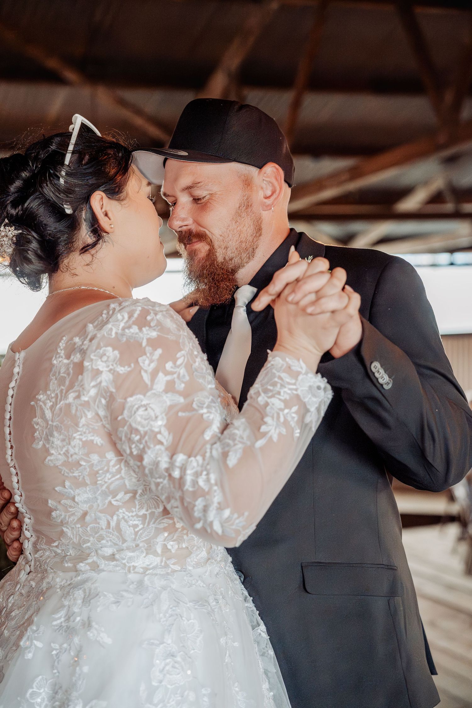 A romantic moment shared between a couple during their first dance at their wedding reception.