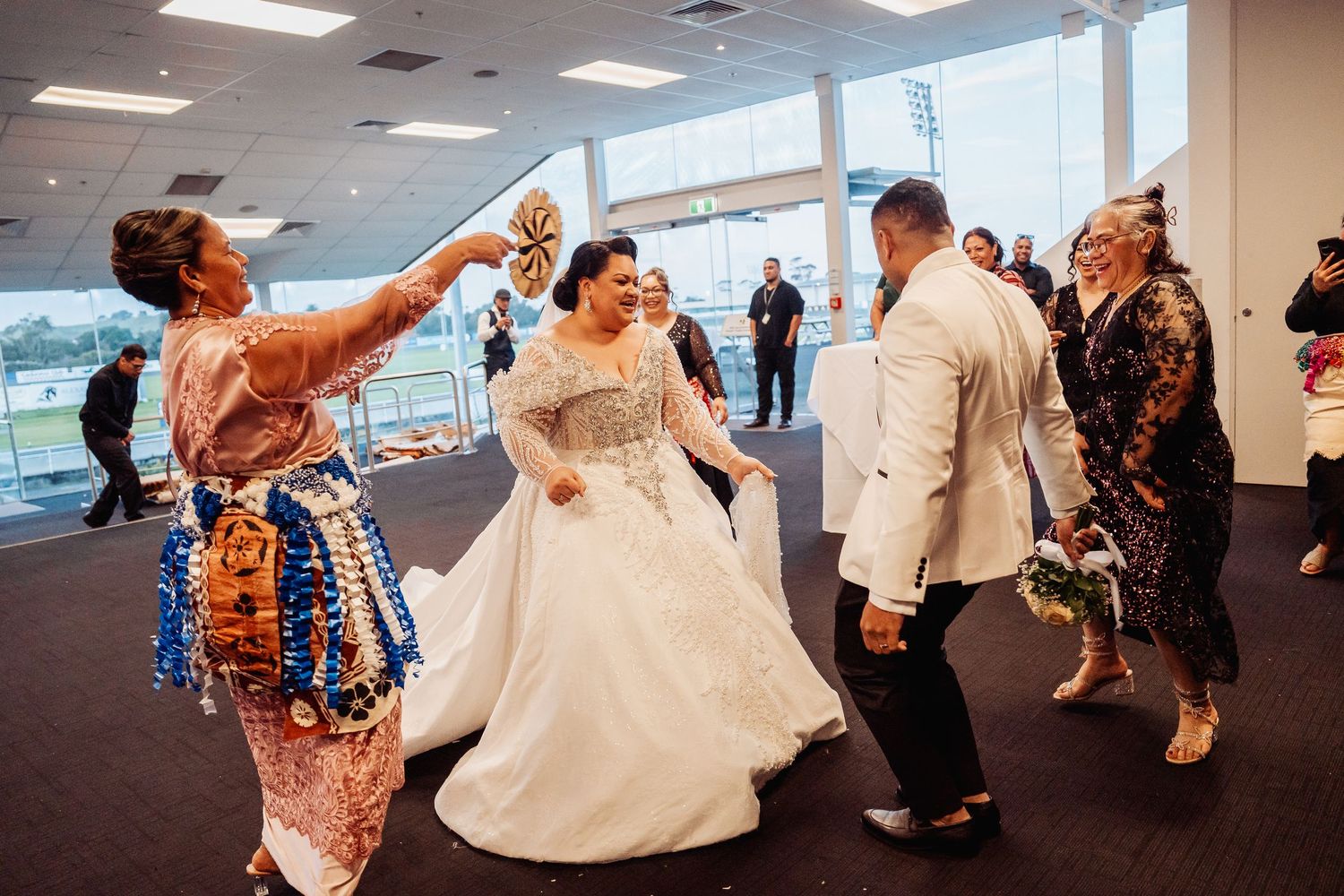 Wedding reception dance floor filled with guests celebrating and dancing.