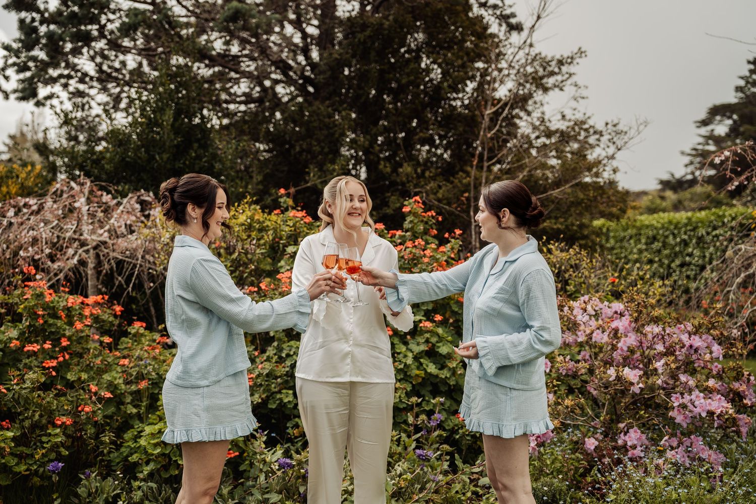 A romantic outdoor garden wedding ceremony with blooming flowers and natural scenery in the background.