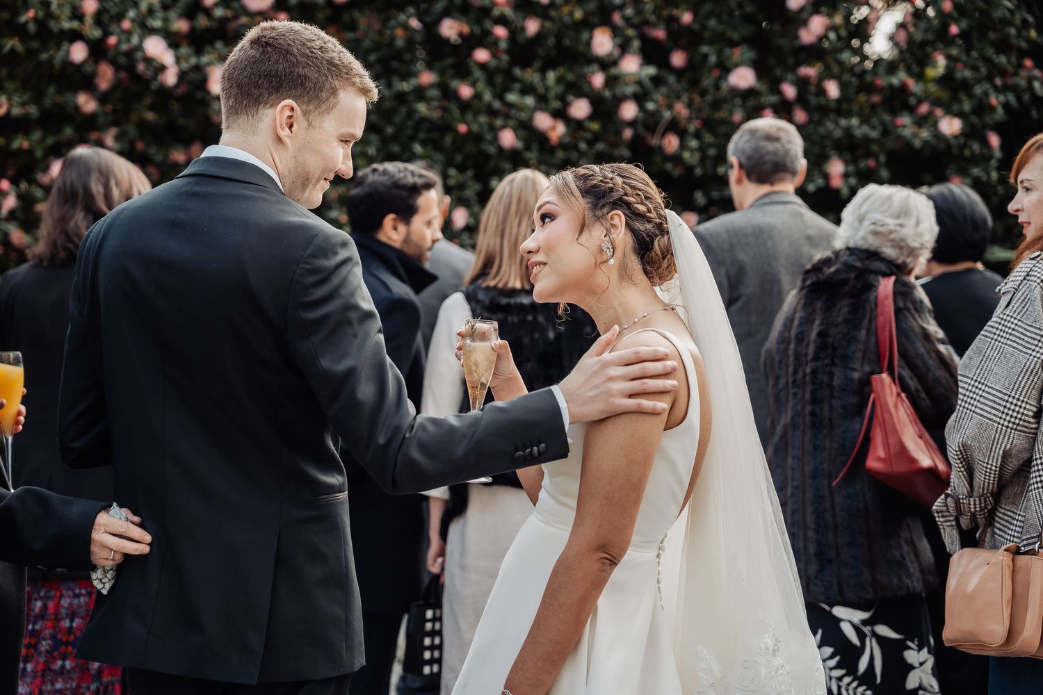 Guests gathering and mingling at an elegant outdoor wedding ceremony.