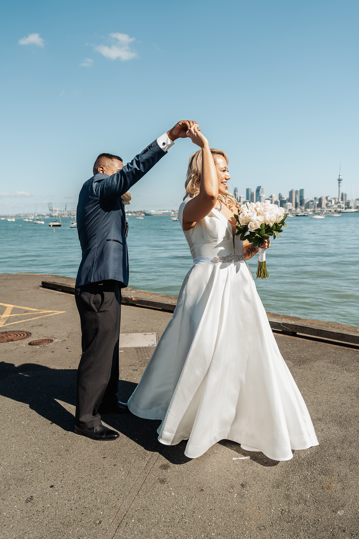 Waterfront wedding dance with Seattle skyline in background.