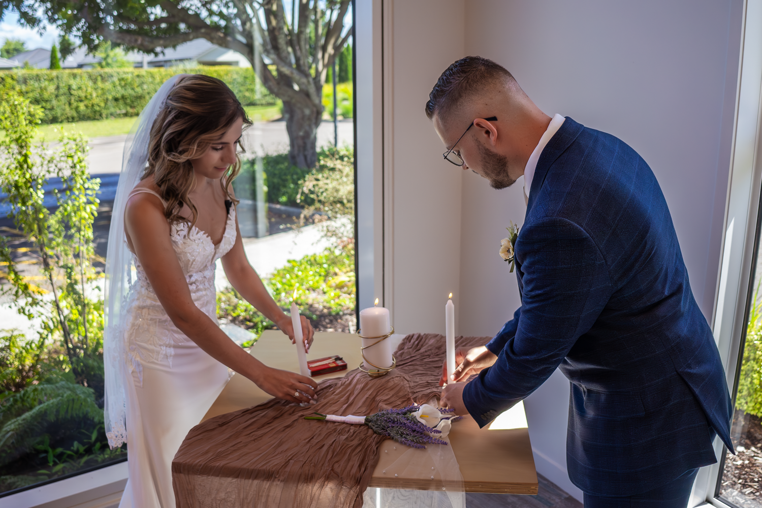 A couple participates in a unity candle ceremony during their wedding.