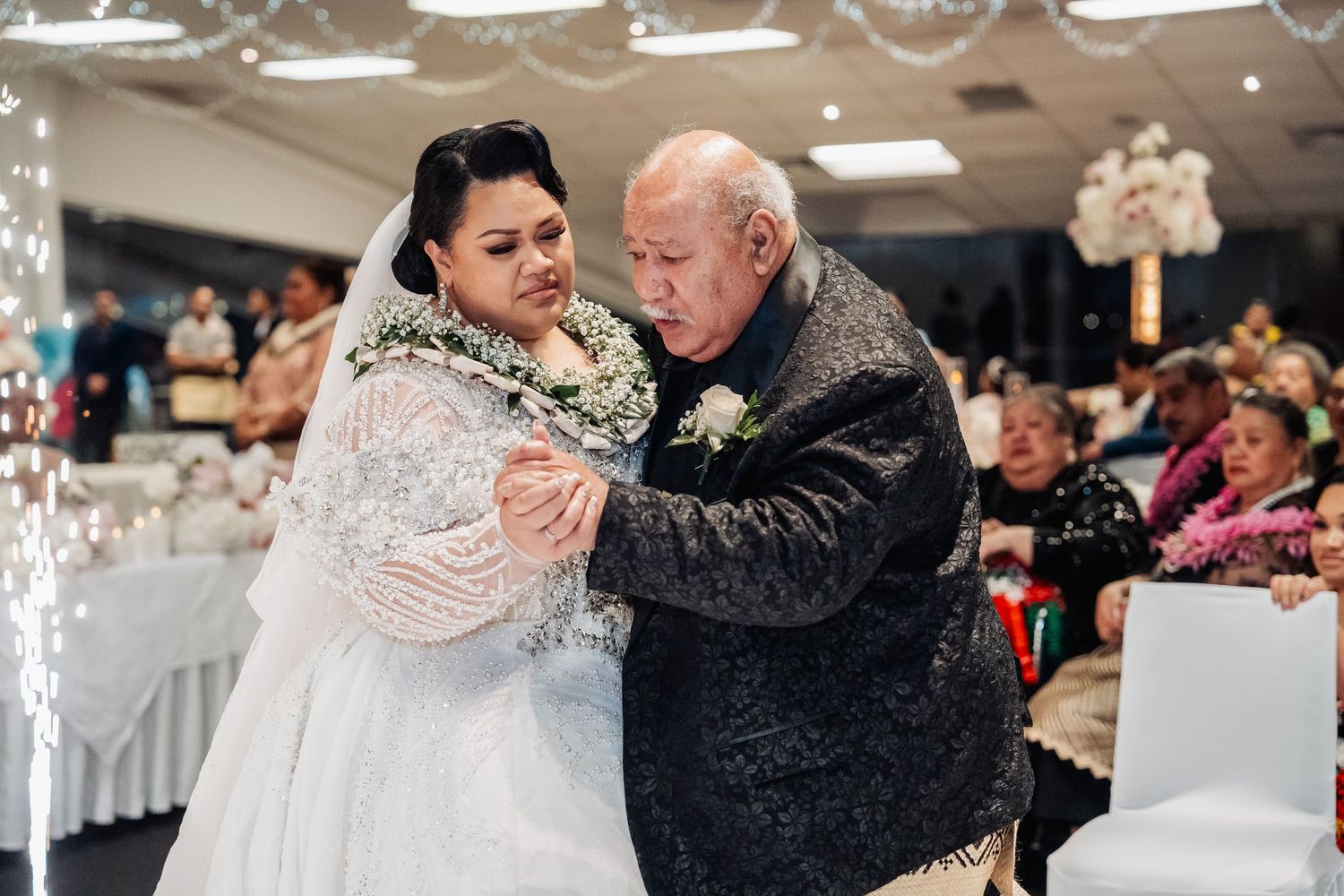 Special moments during a wedding celebration in an ornately decorated reception hall.
