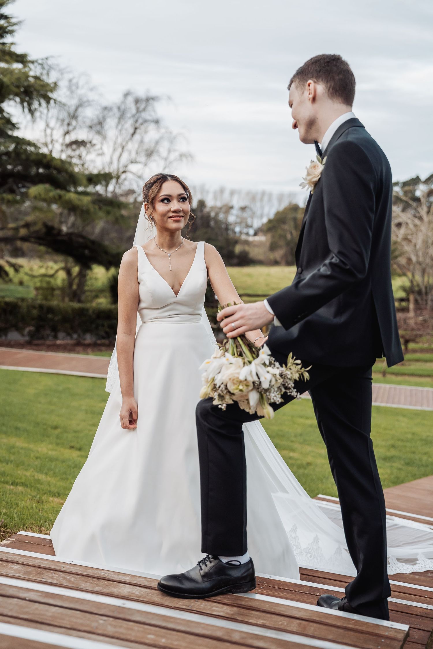 Special wedding moments photographed on a garden pathway showing interactions between the newlyweds.