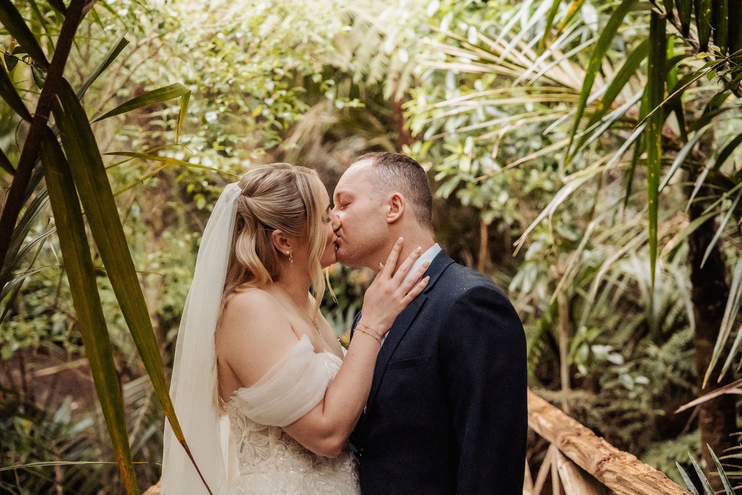 Romantic moment captured in a lush tropical garden setting.