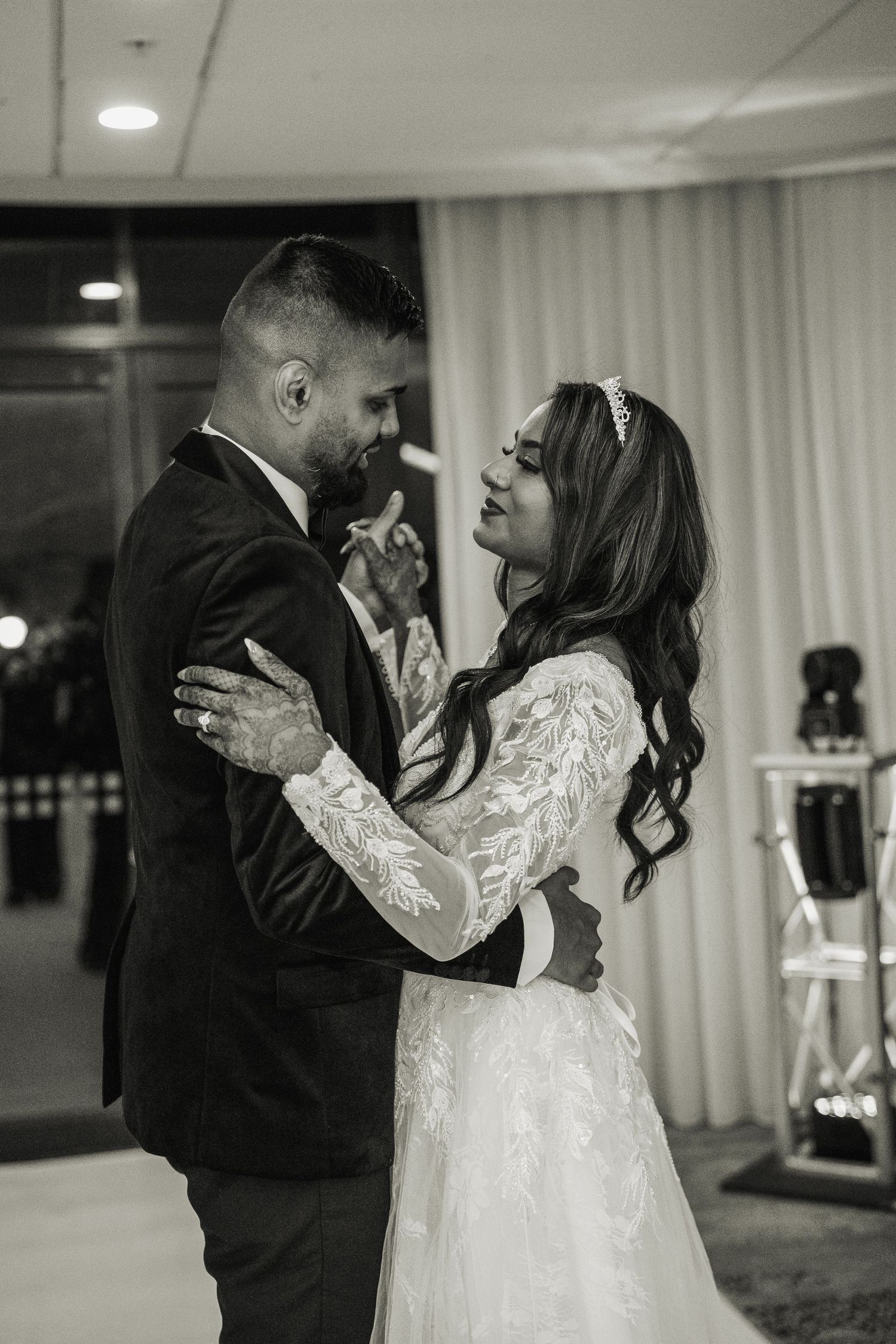 Black and white wedding dance photos capture couple's romantic first dance in reception hall.