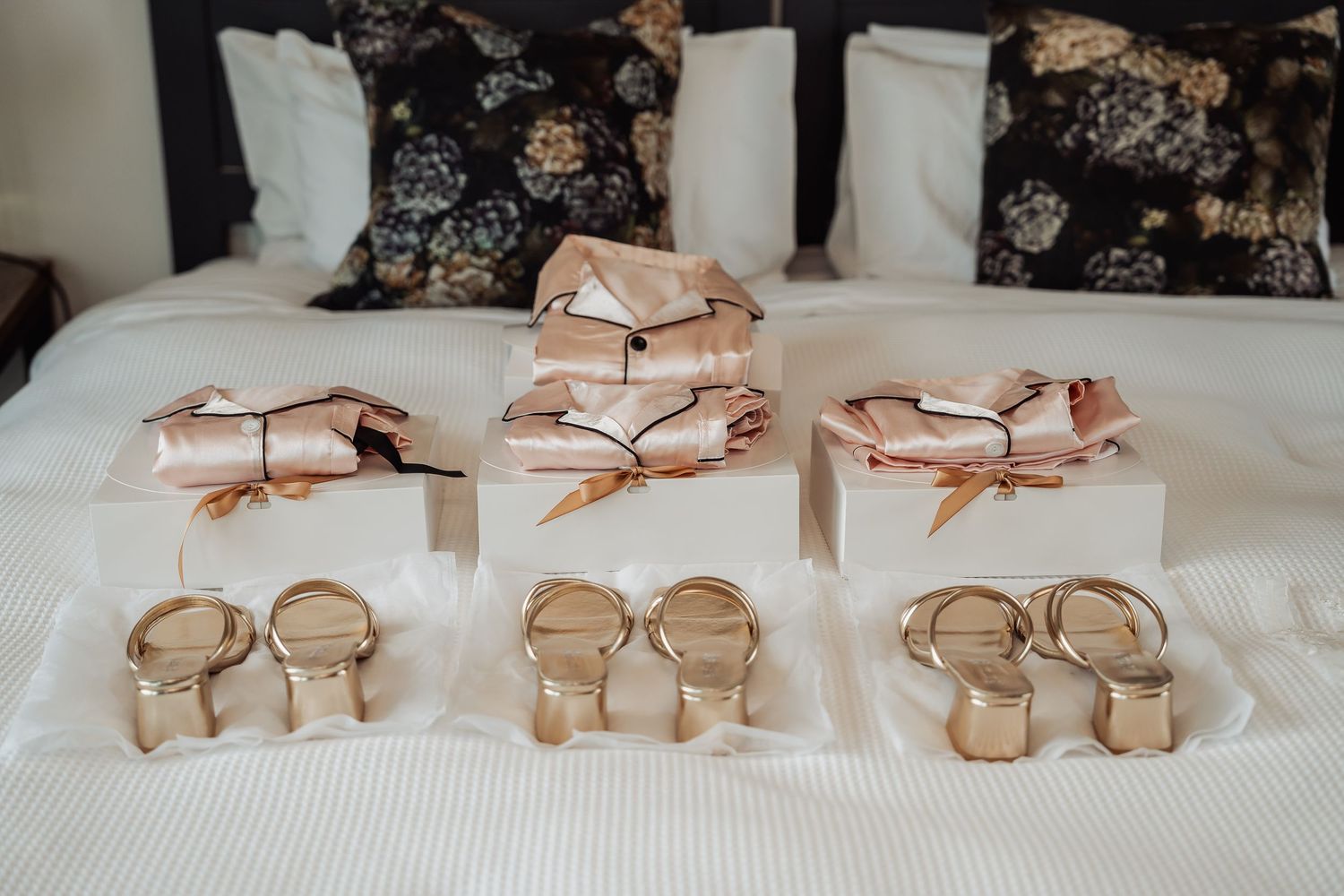 Rose gold sunglasses arranged in neat rows on a white display shelf showcase elegant eyewear collection.