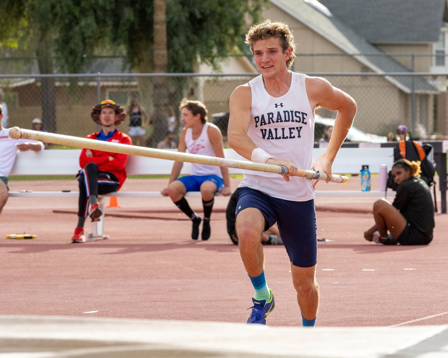 Pole vaulter running with his pole.