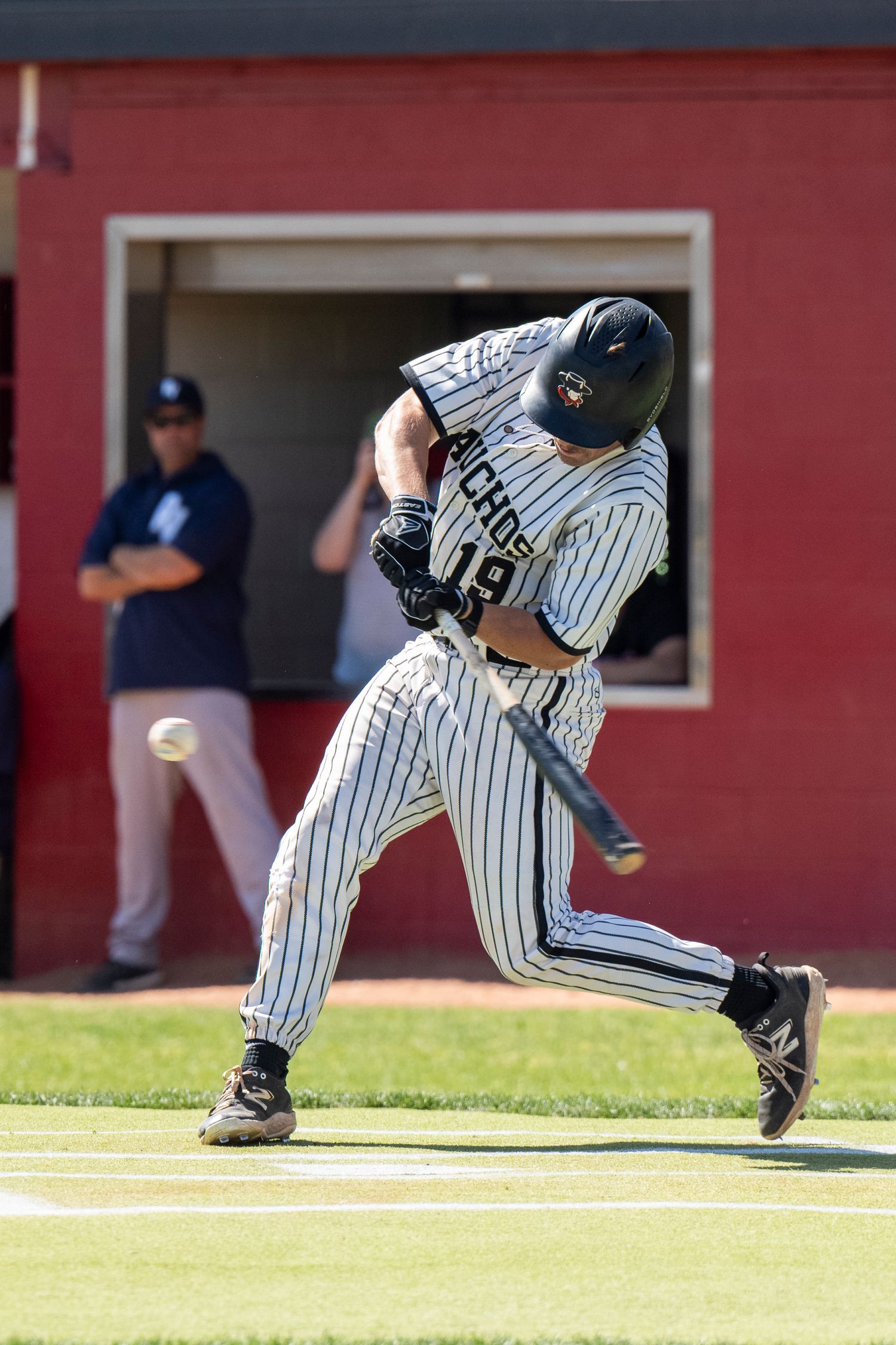 Baseball player hitting a ball.