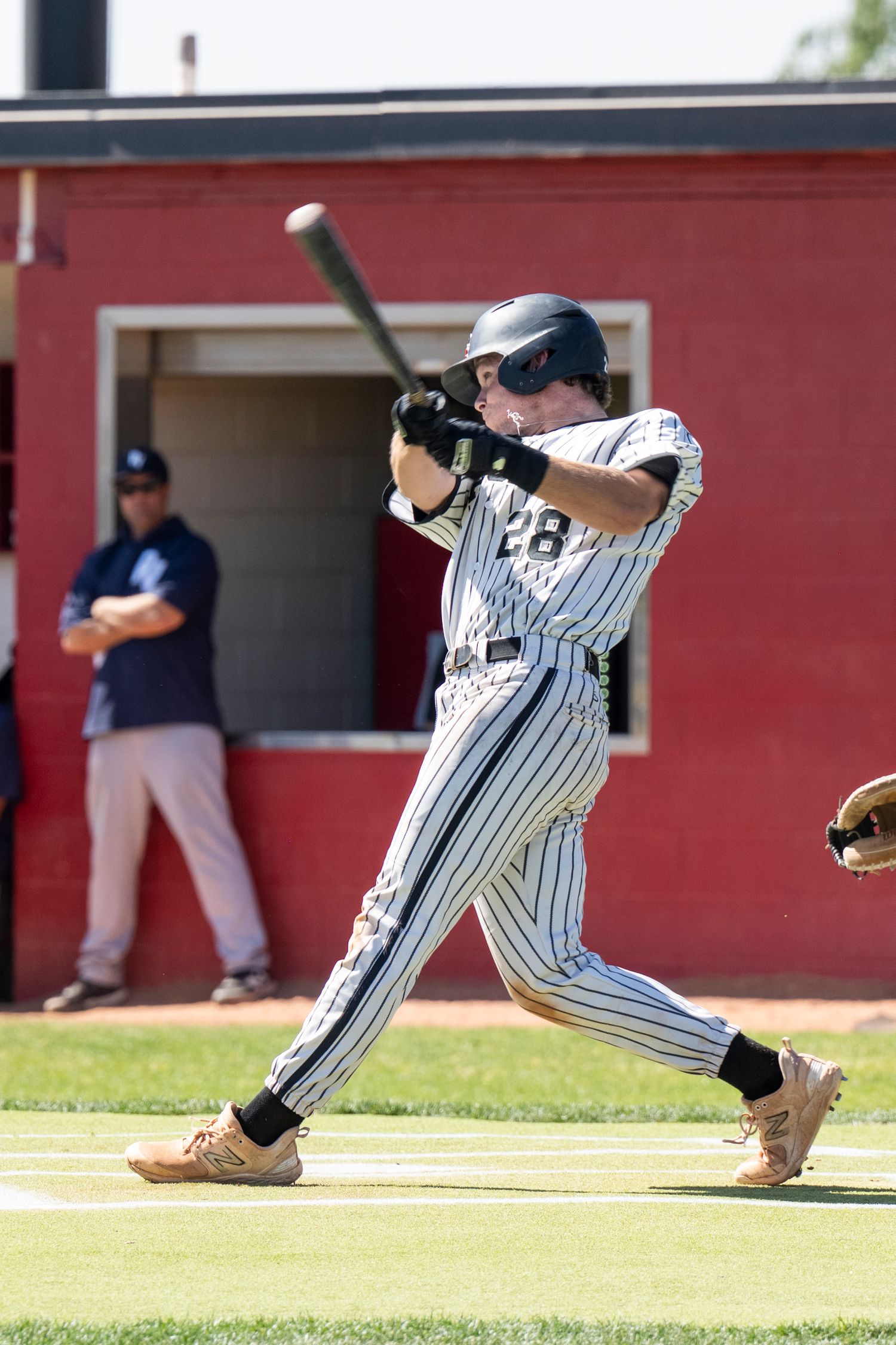 Baseball player hitting a baseball.