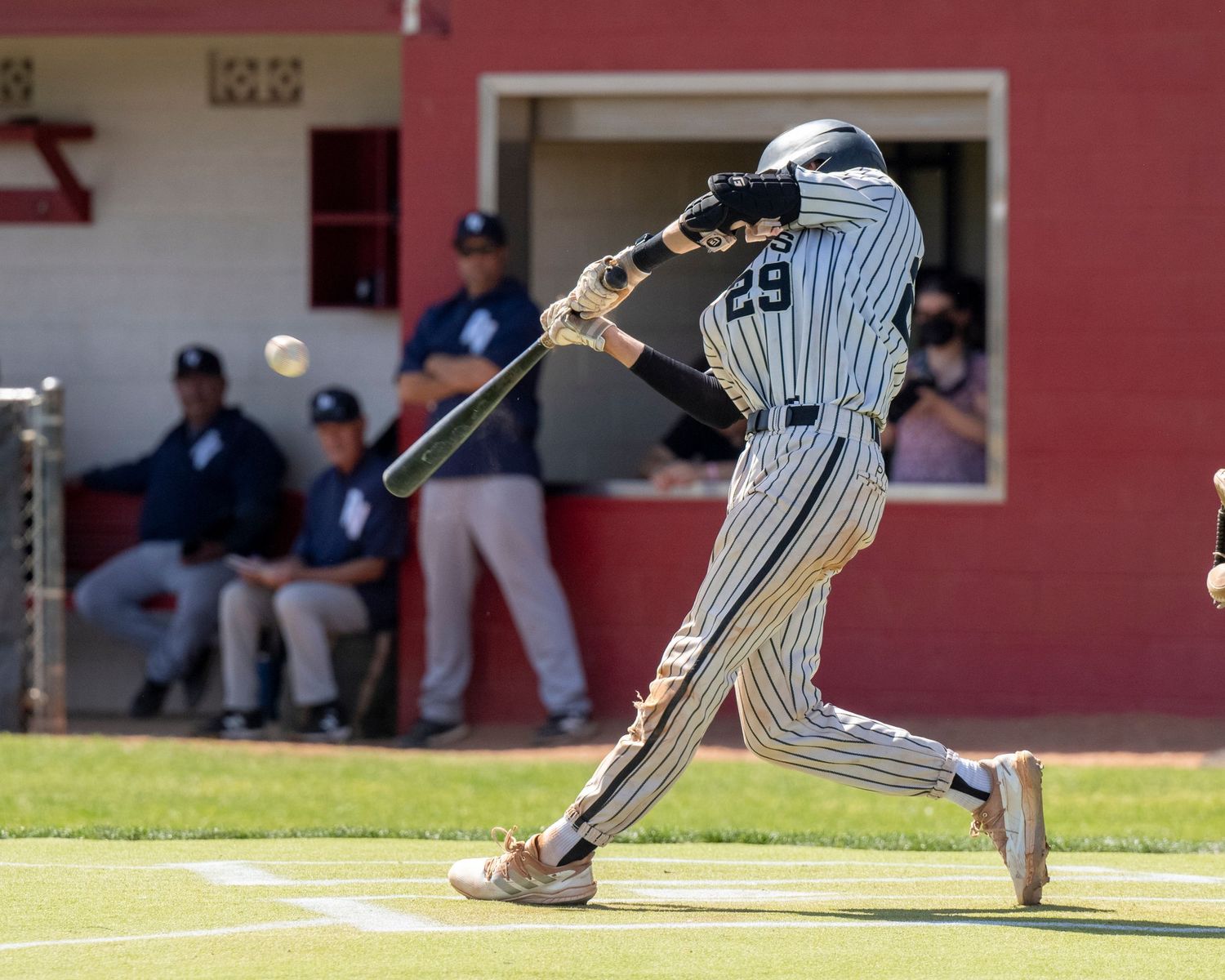 Baseball player hitting a baseball.