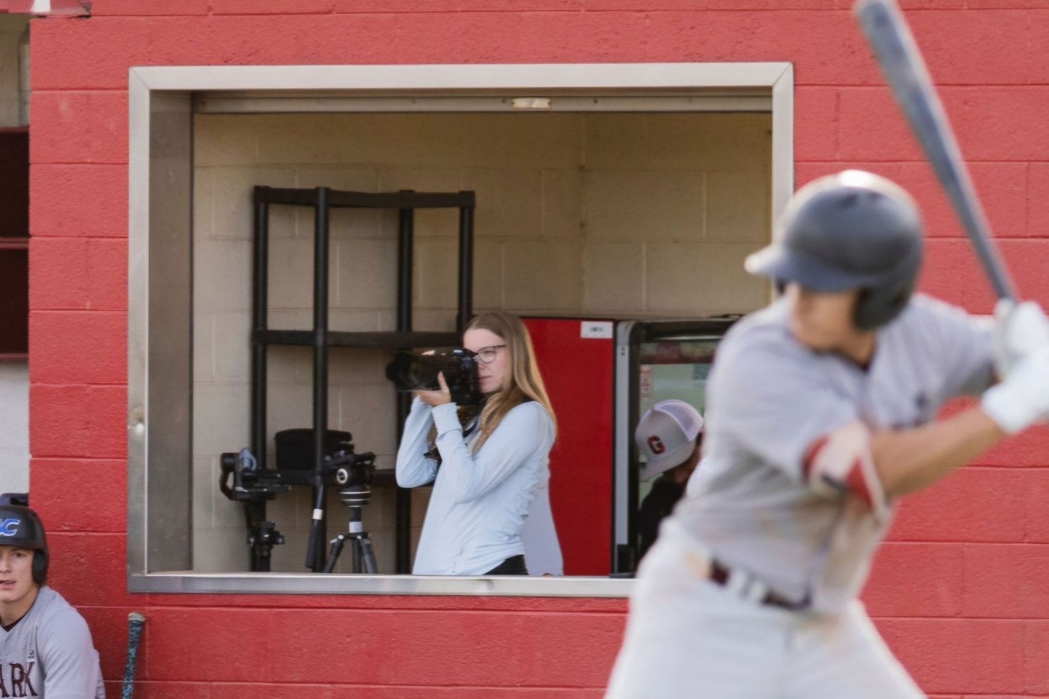 Danielle Gantt actively taking a photo at a GCC Baseball game.