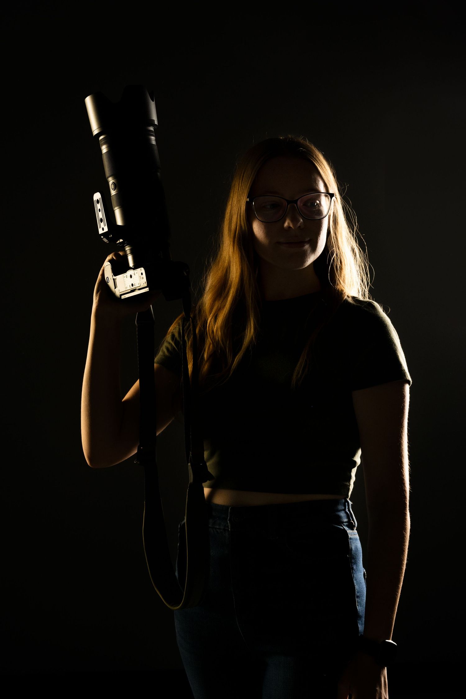 Danielle Gantt posed in a moody photo with a camera.