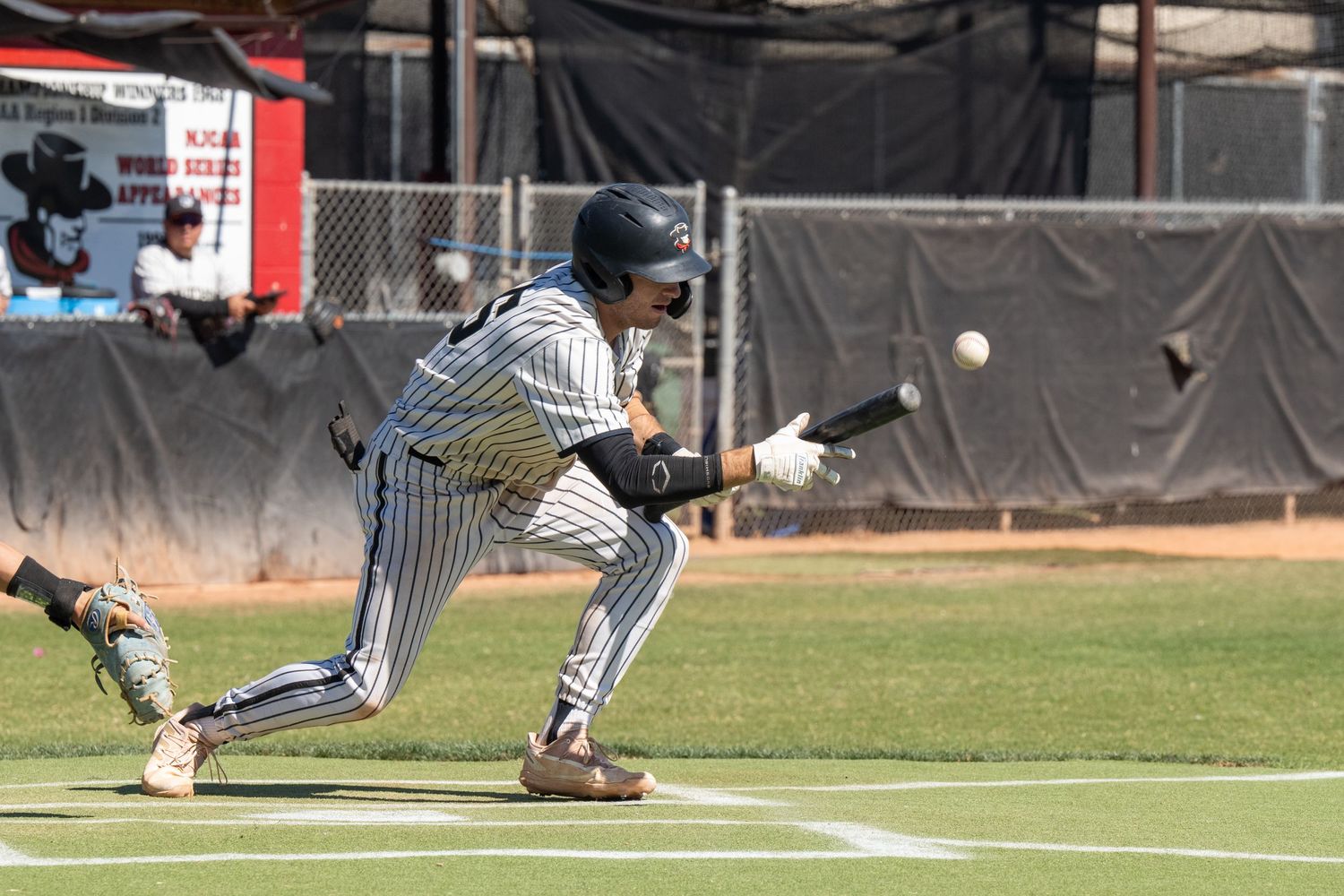Baseball player hitting a ball.