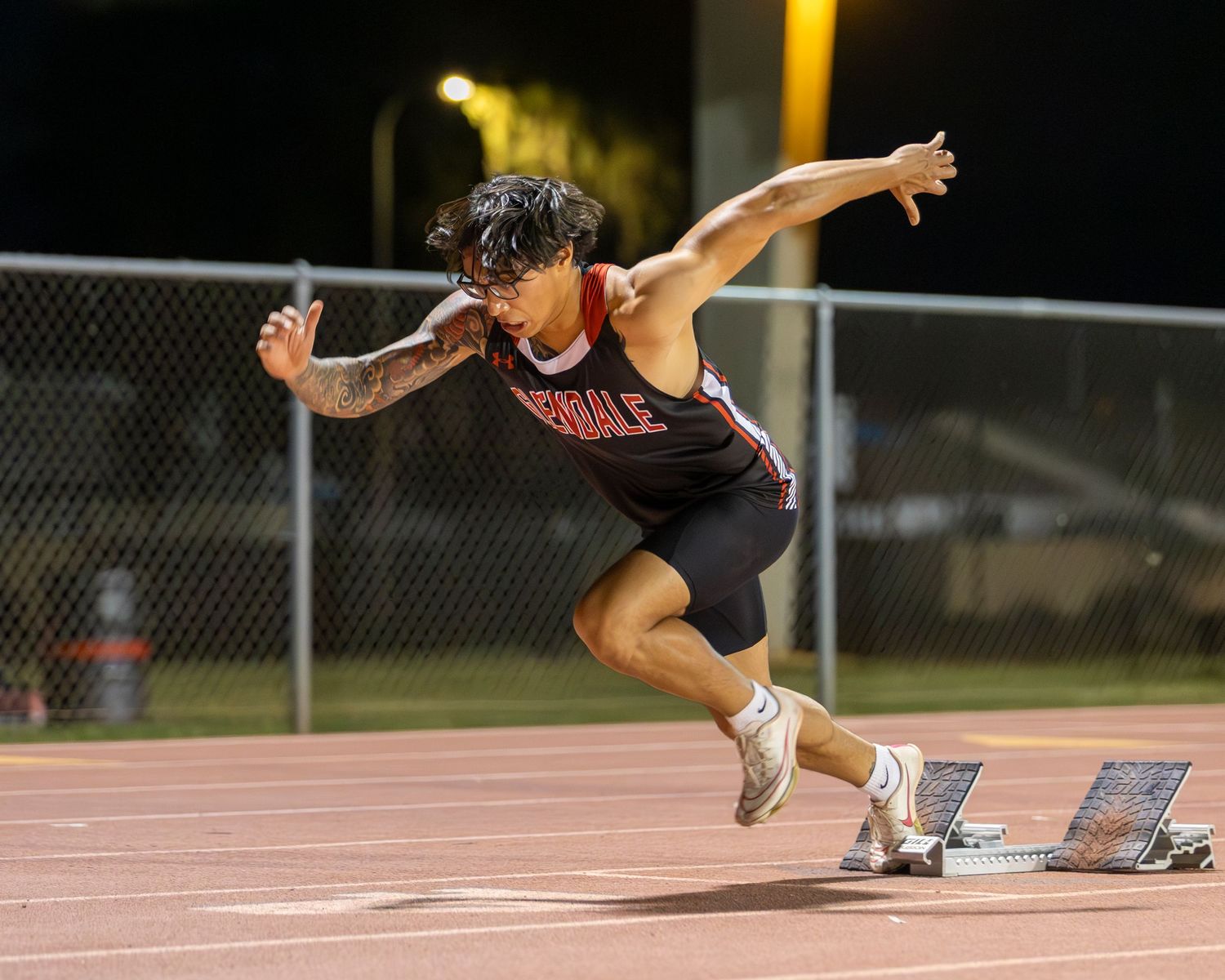 Track runner taking off from the starting line.