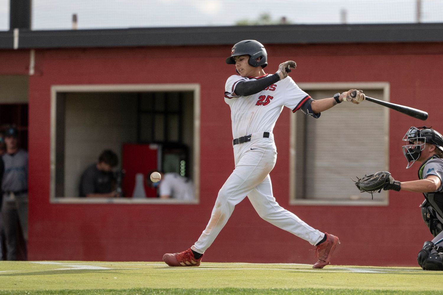 Baseball player on home base batting.
