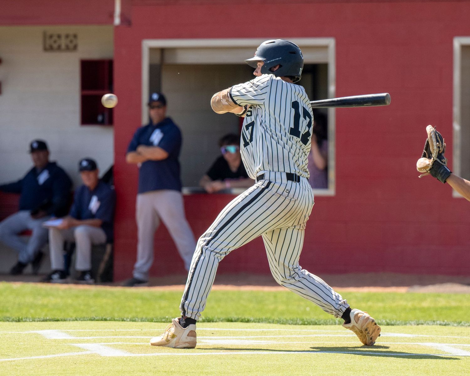 Baseball player hitting a baseball.