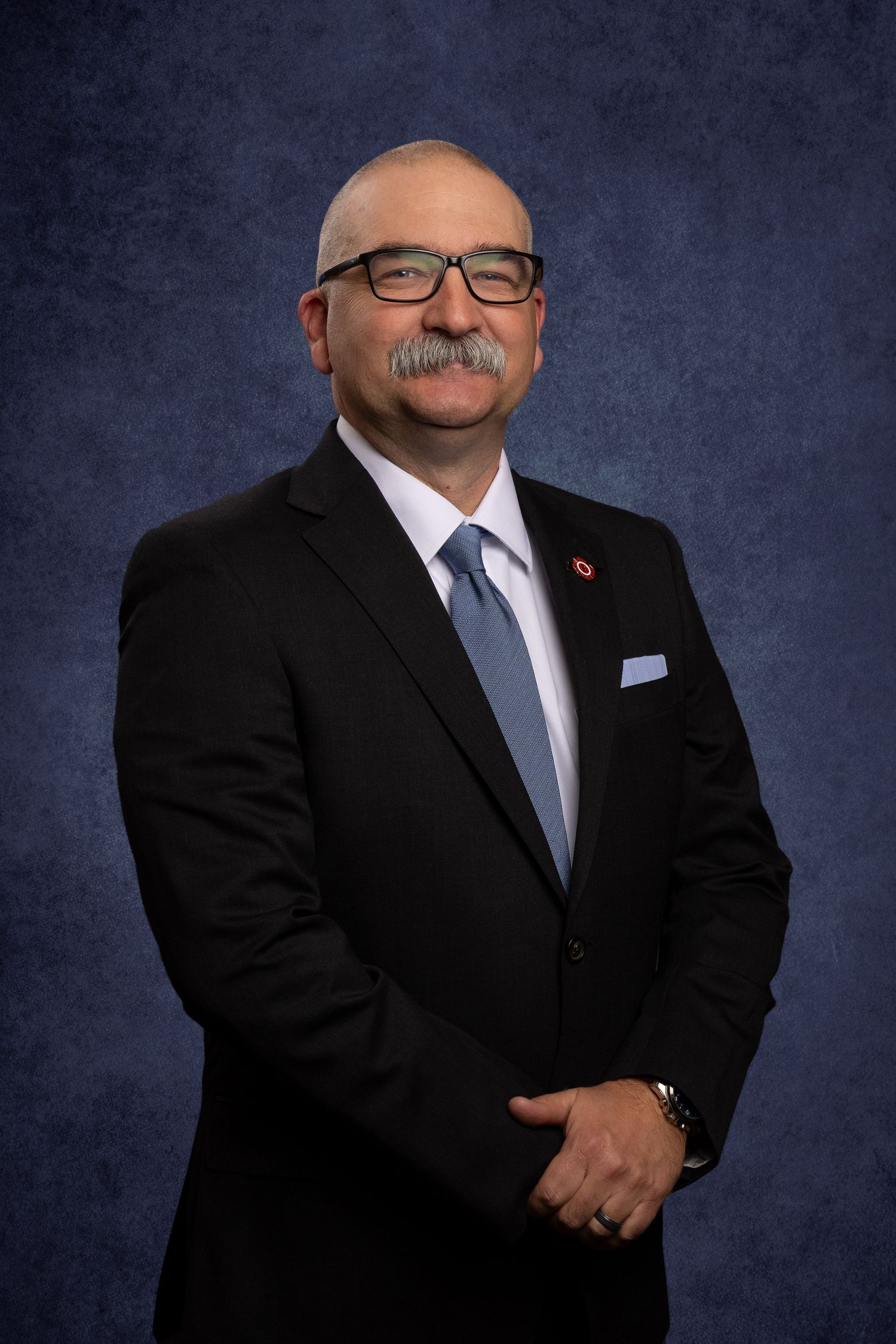 Headshot of member of non-profit, Tennessee Professional Firefighters Association on virtual background, professional and classic.