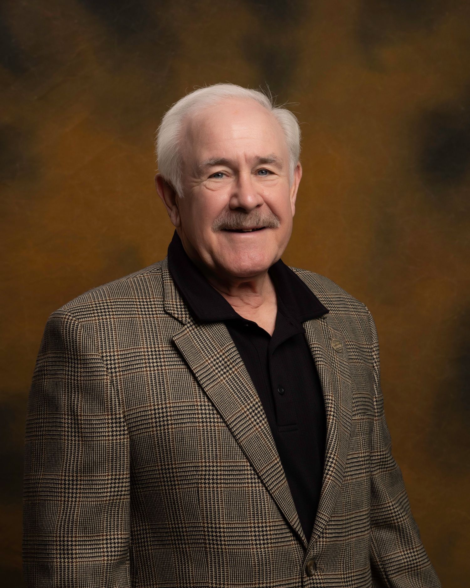 Executive headshot for board member, friendly and polished look with custom background, captured for NWTF Foundation.