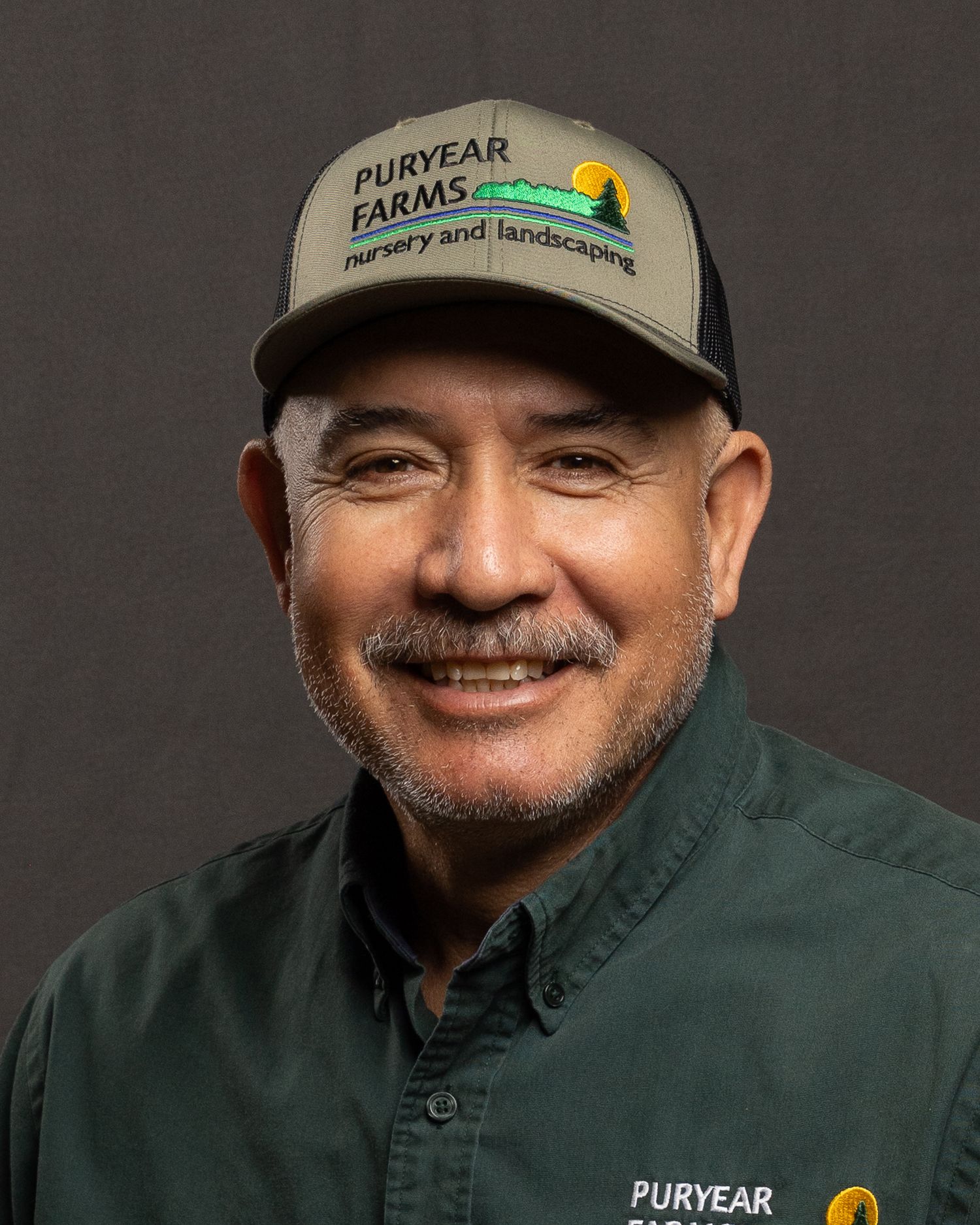 Management headshot for Puryear Farms, approachable demeanor and classic, photographed with portable backdrop and lighting.
