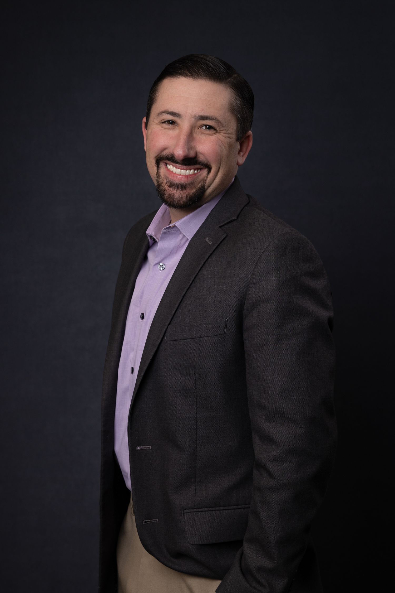 Portrait of team member at Quality Uptime, consistent and personable expression, photographed under natural studio light.