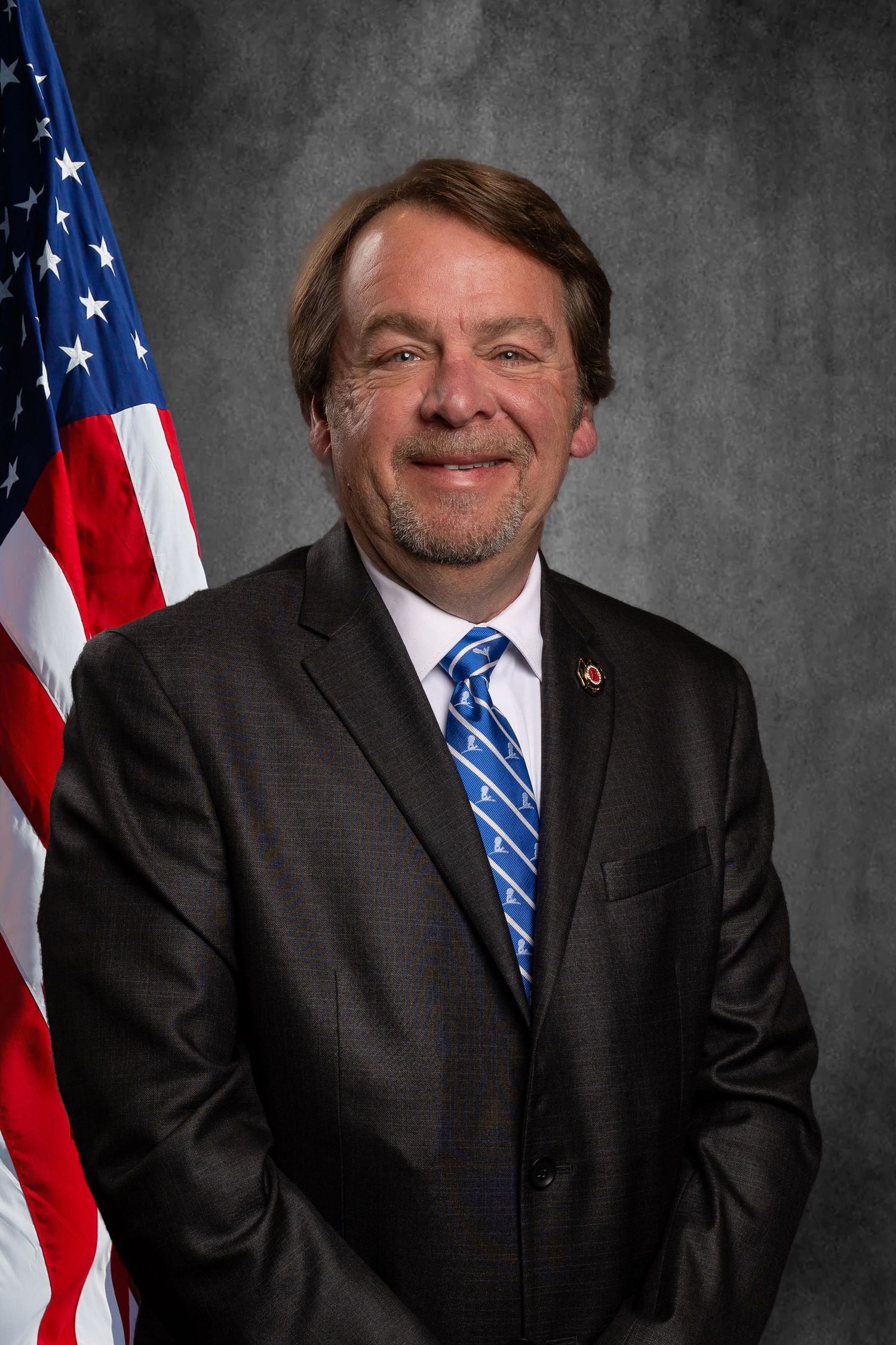 Non-profit headshot for member of Tennessee Professional Firefighters Association on virtual background.