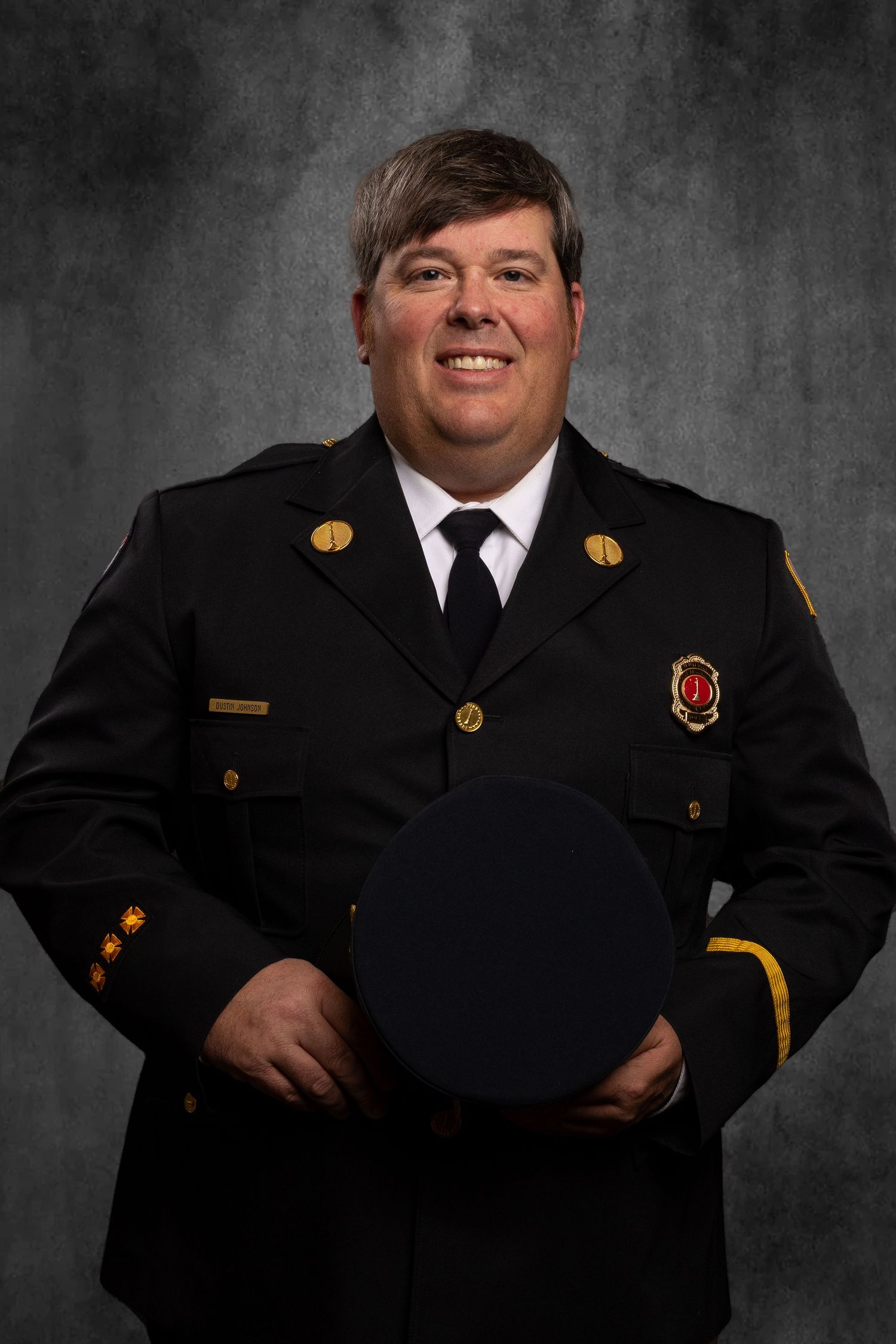 Headshot of member of non-profit, TN Professional Firefighters Assoc. on virtual background, clean and professional.