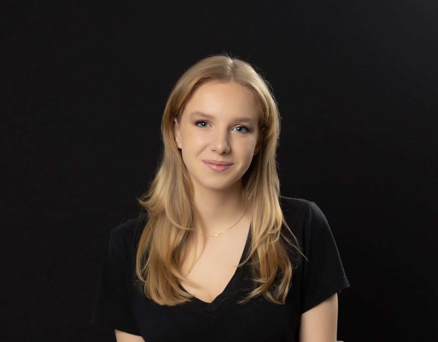 Professional headshot for 31Digital , smiling confidently against modern black backdrop under bright studio lighting.