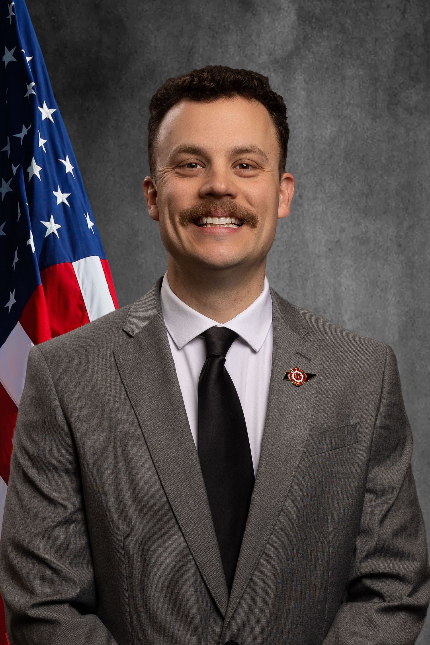 Non-profit headshot for member of TPFFA on virtual background with American flag.