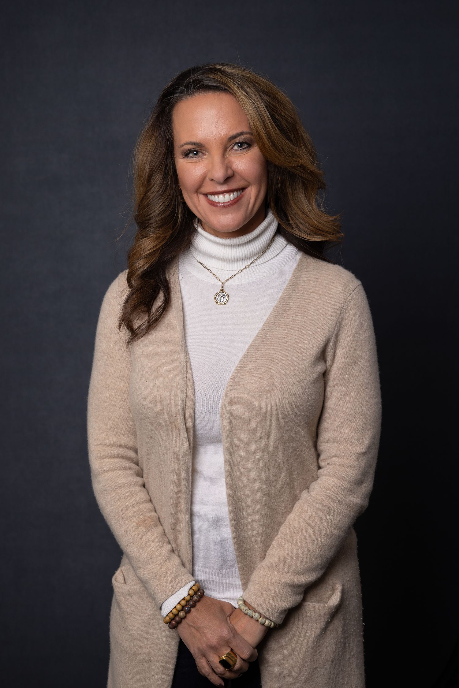 Portrait of team member at Quality Uptime, timeless and personable expression, photographed under natural studio light.