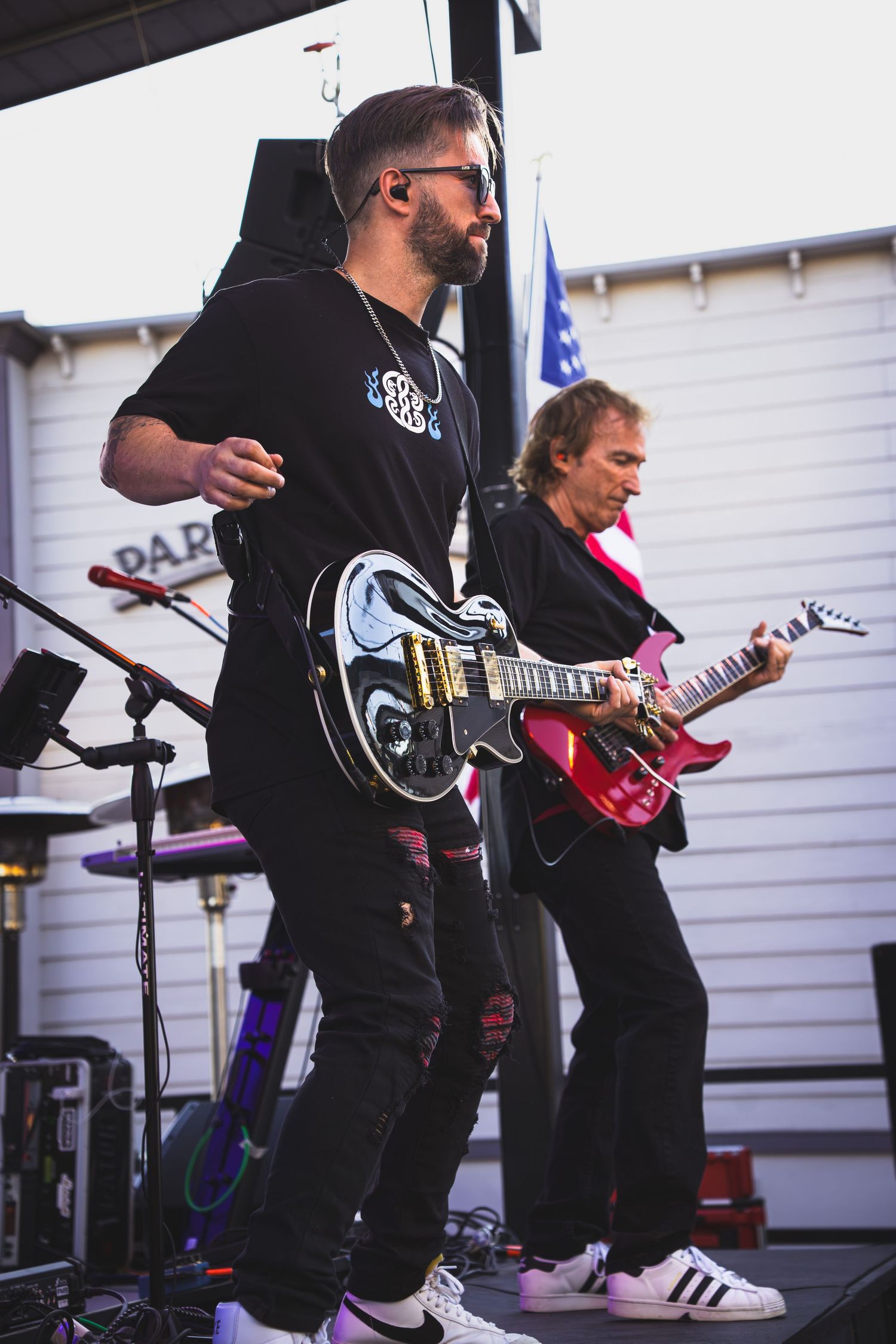 Guitarist strumming instrument on stage during rock concert