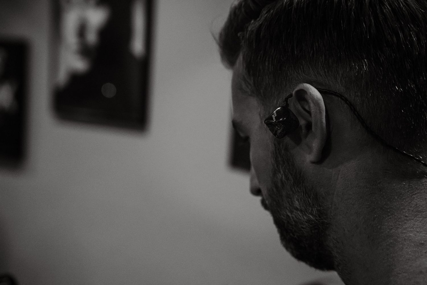 Black and white closeup of performers in-ears during a music performance