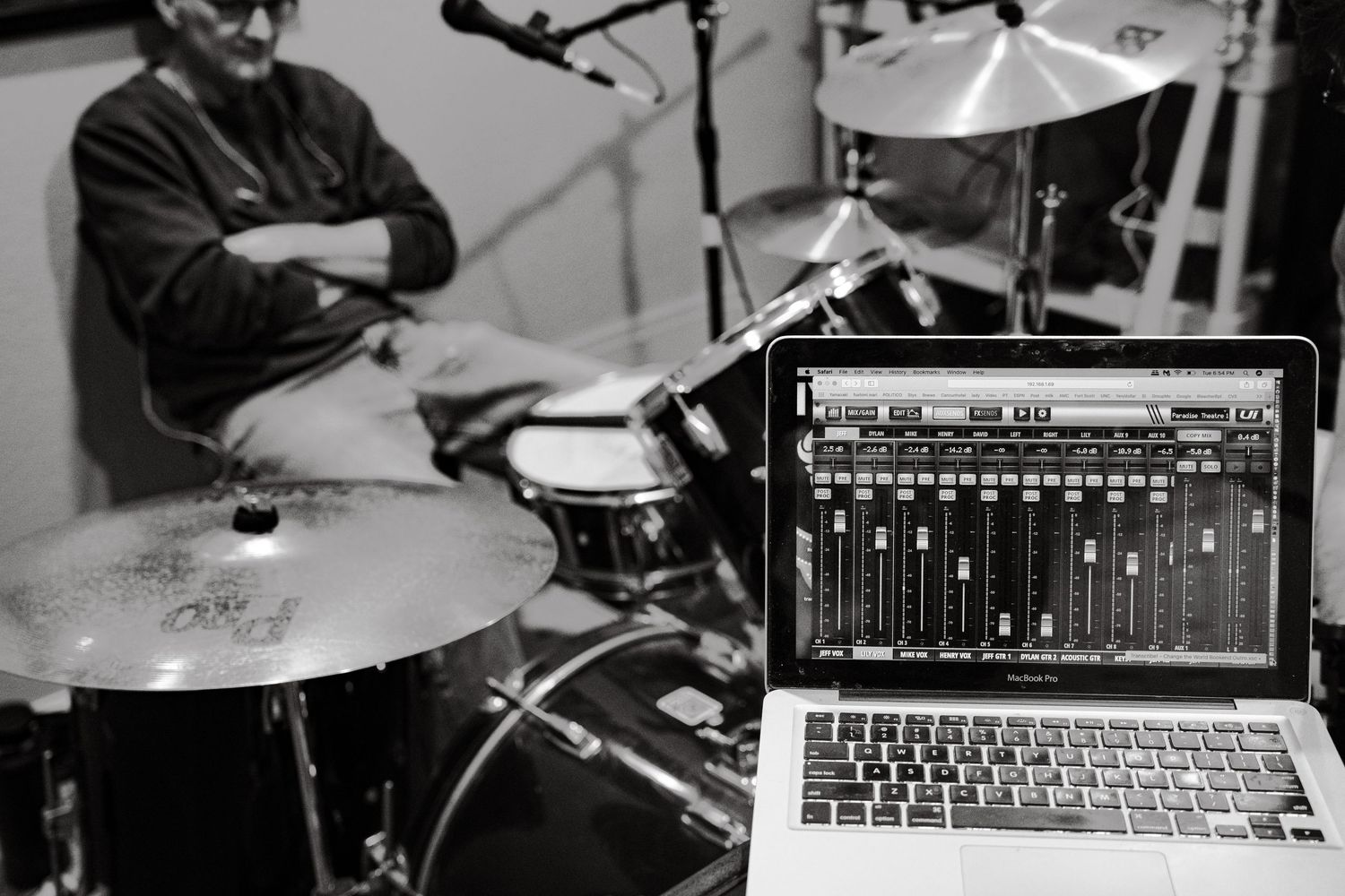 Black and white closeup of music equipment and laptop sound mixer