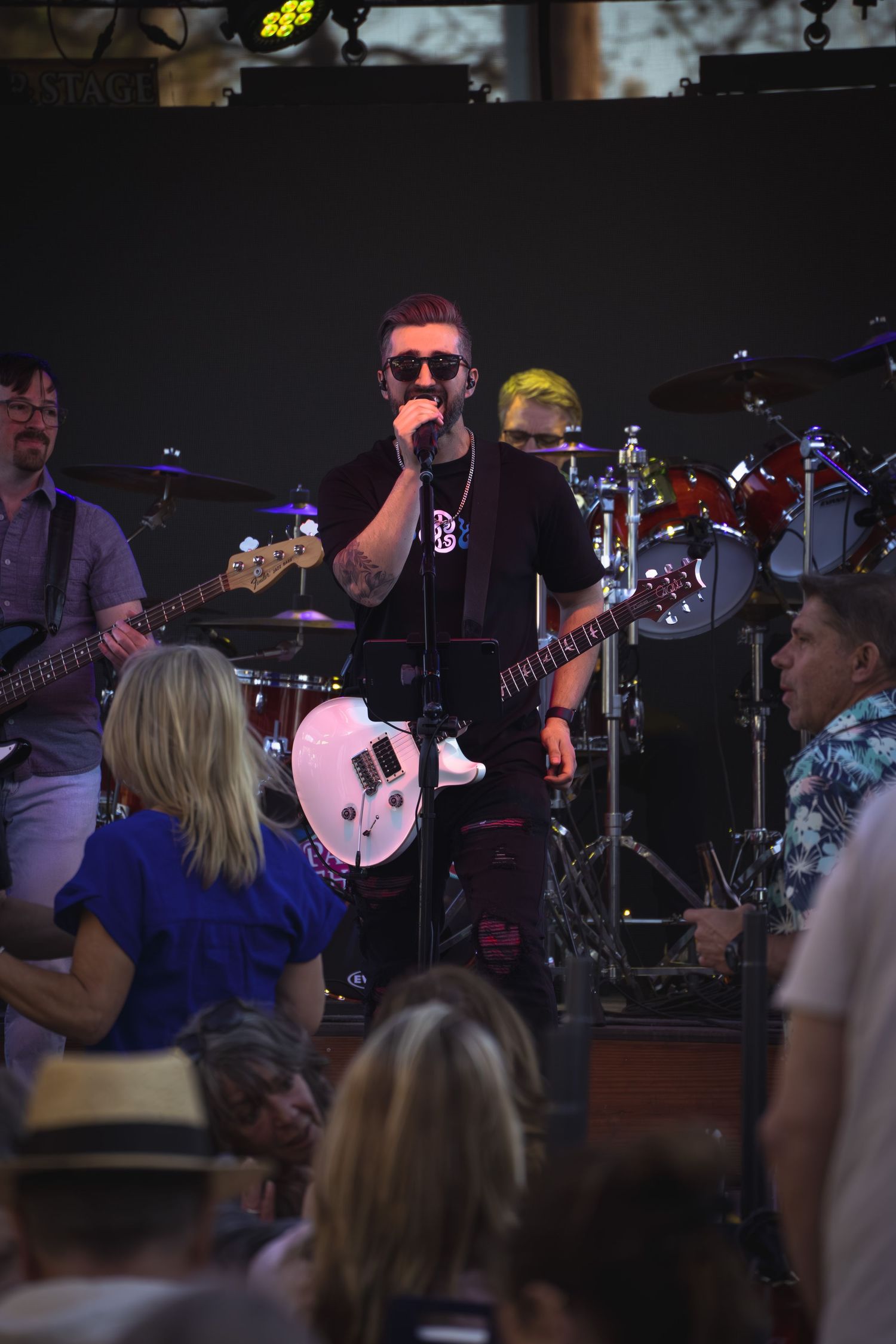 Guitarist singing on stage during a concert
