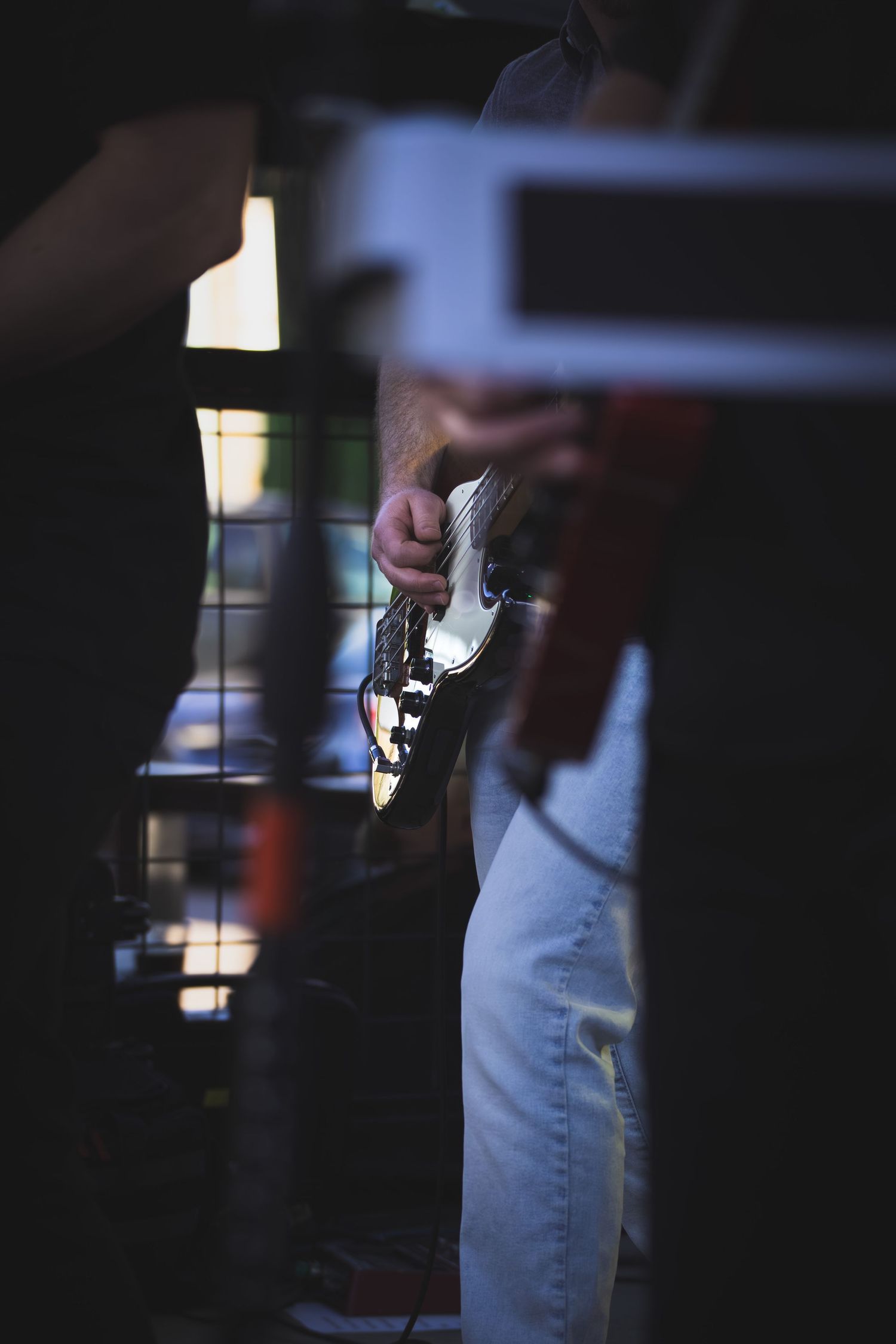 Close up of a bass-players hands while playing on stage