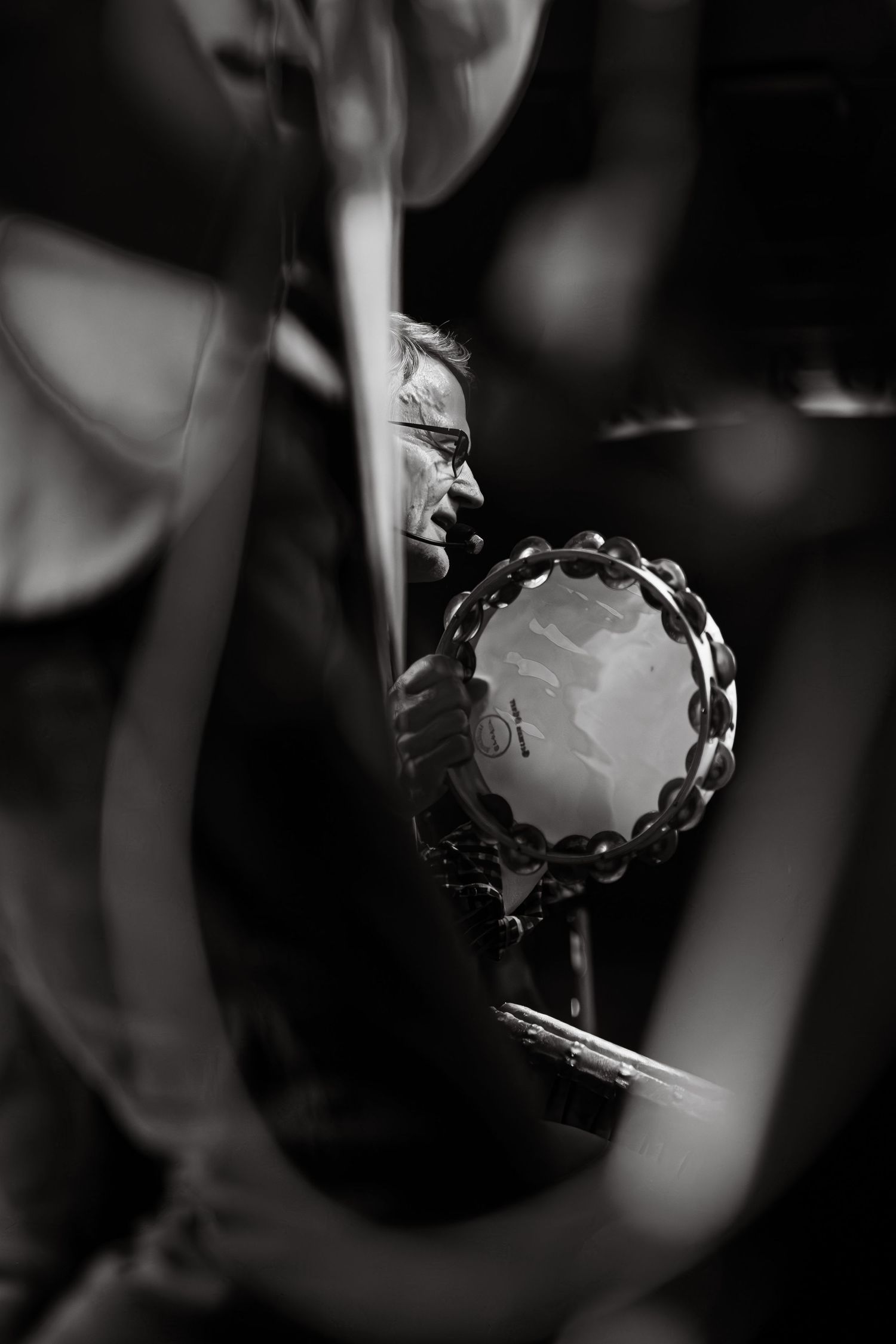 Black and white close up of drummer with a tambourine