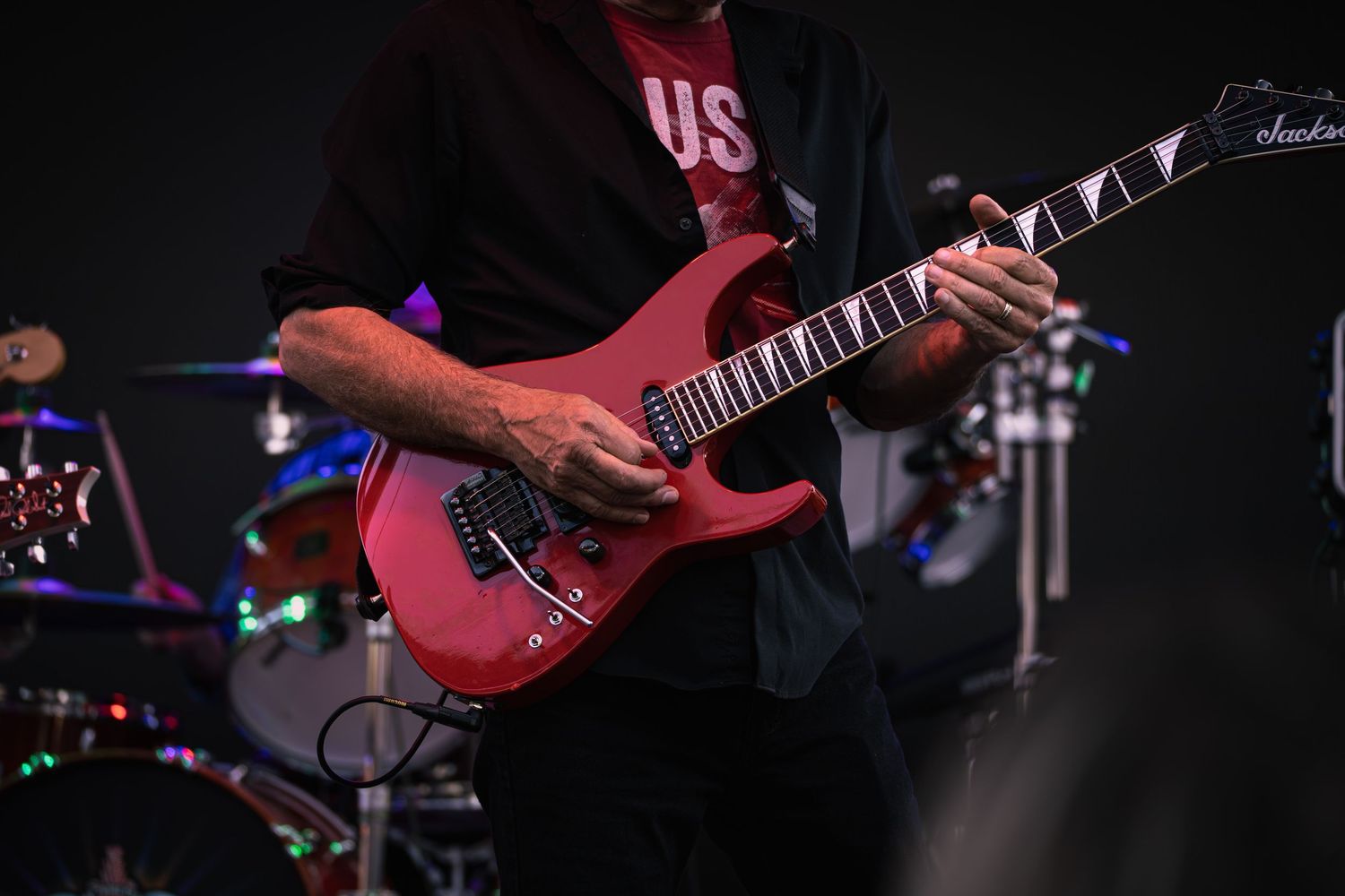 Close up of a red electric guitar during a concert performance