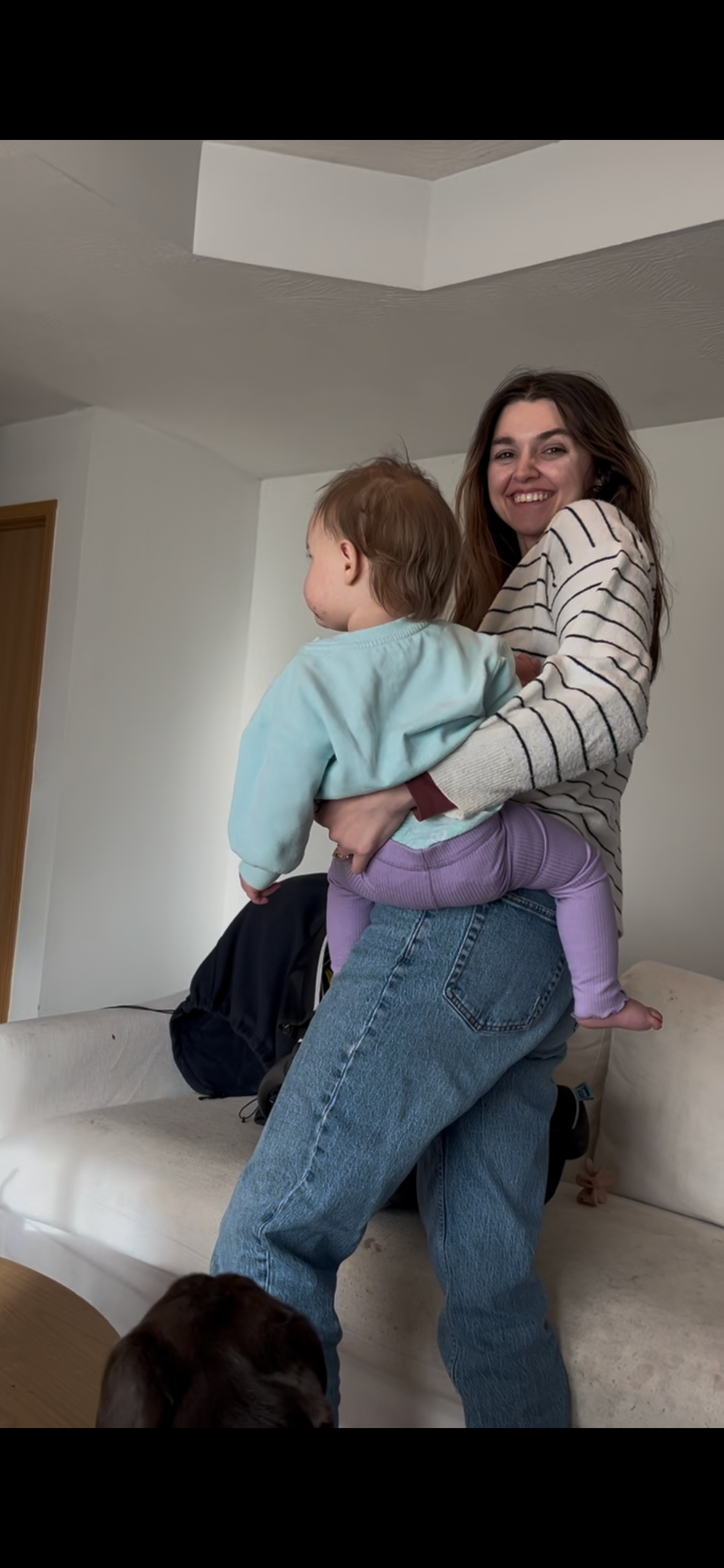 A heart-warming indoor moment of joy and playfulness with a child in blue and purple clothing captured at home in Springfield, Missouri.