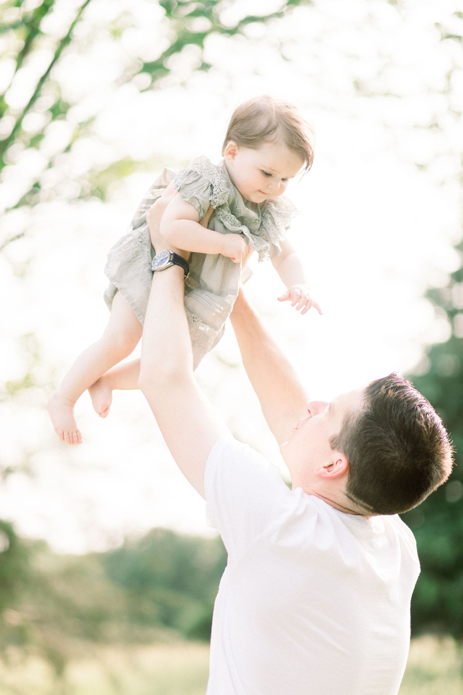 A tender moment captured in a series of photos showing a father lifting and playing with his baby in Marshfield, MO.